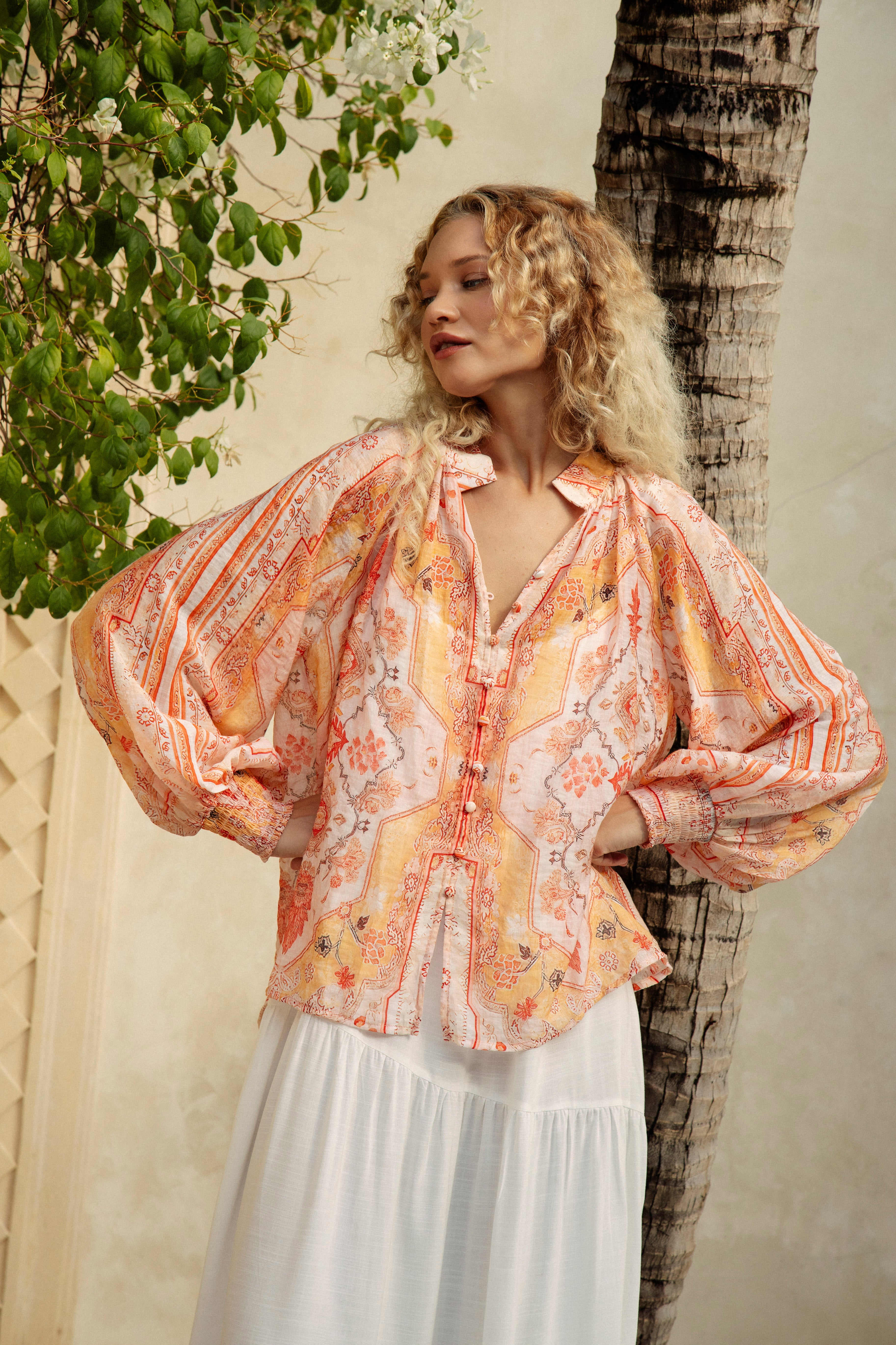 The feminine and floaty Indah Blouse is bound to turn heads with its striking colour palette and effortless silhouette.