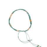 Beaded necklace with green and gold beads on a white background