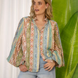 Aurora Blouse Dream showcasing mandarin collar, fabric covered buttons and button down style