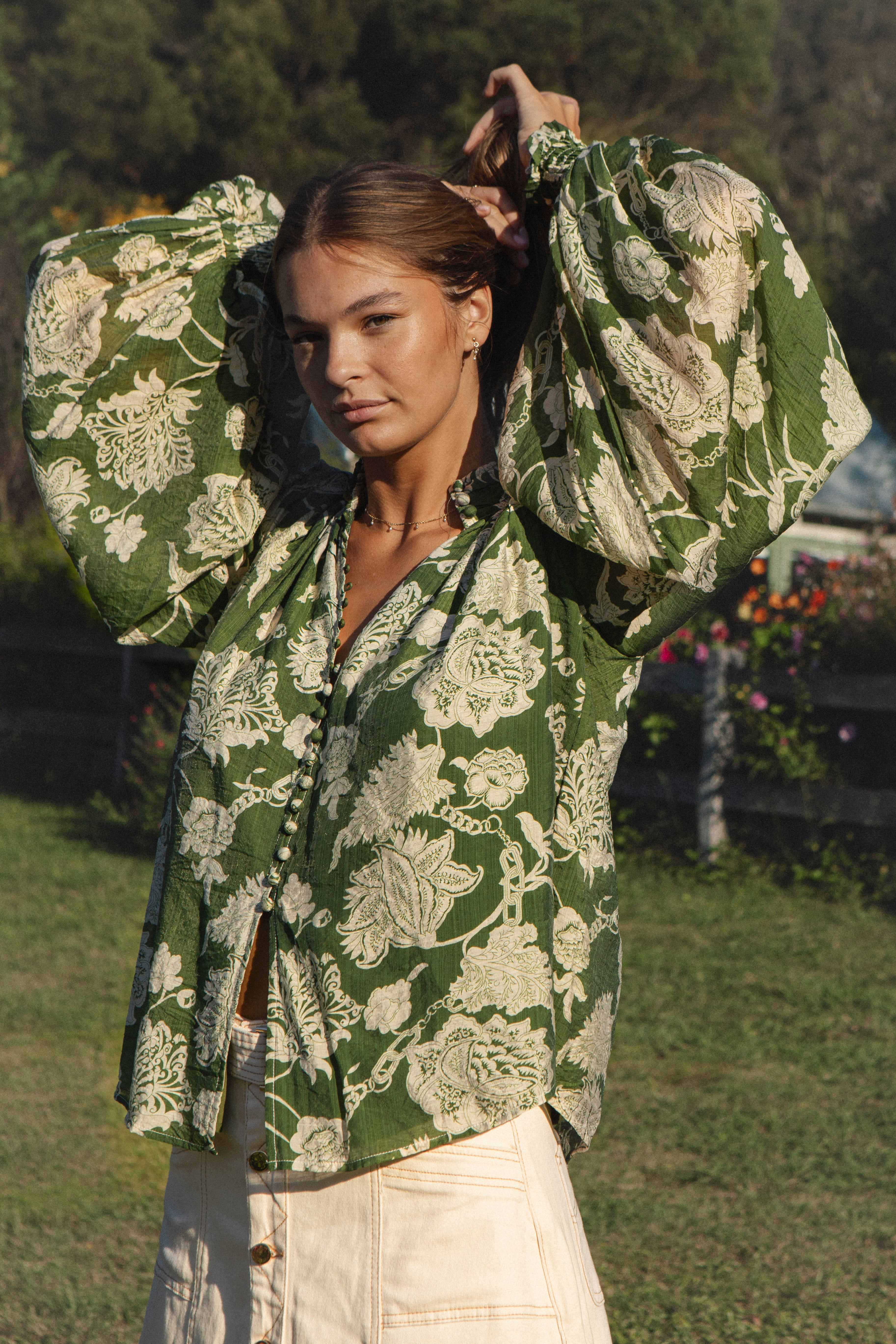 Aurora Blouse Evergreen - green blouse with floral print featuring billowy sleeves and ruched cuff.