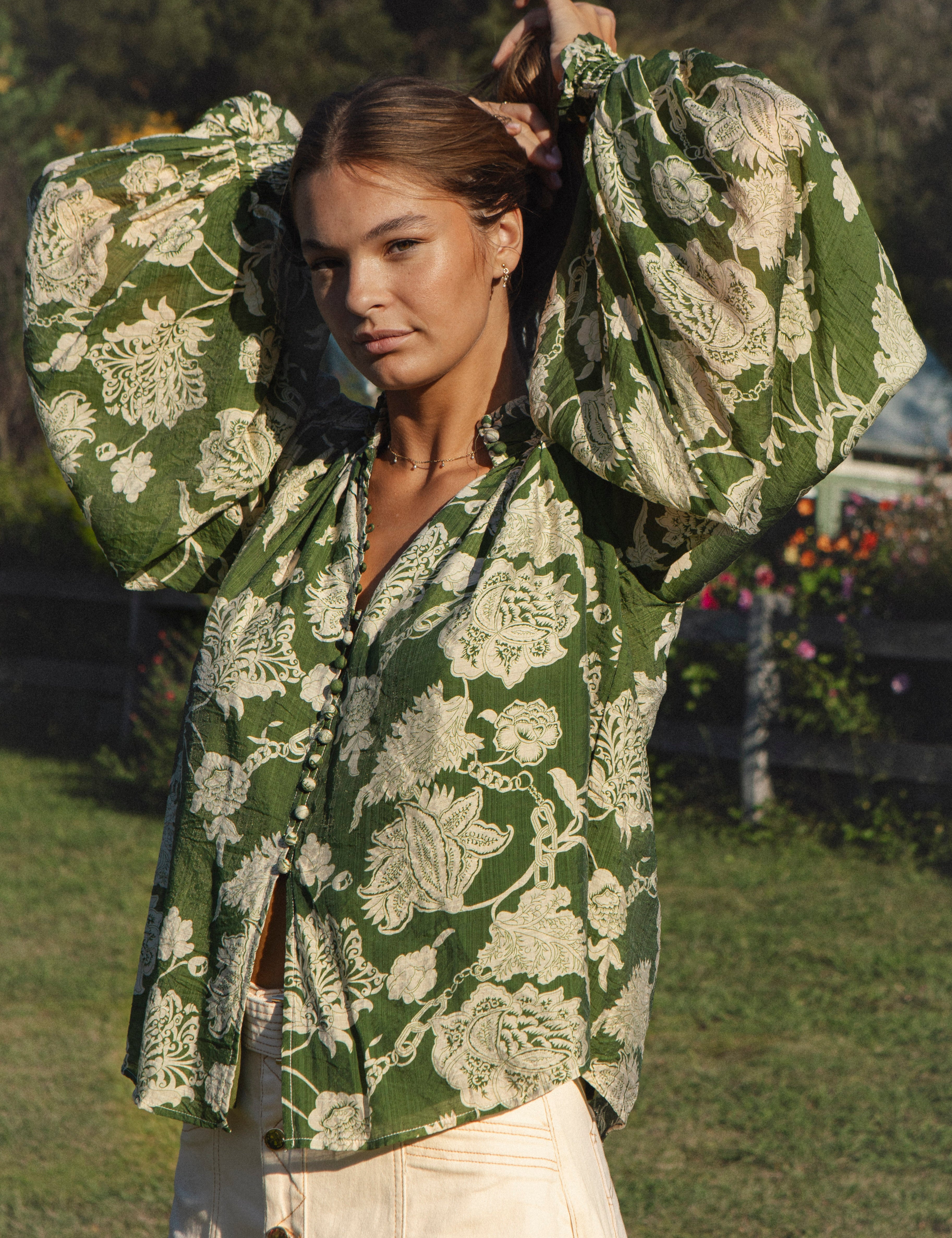 Aurora Blouse Evergreen - green blouse with floral print featuring billowy sleeves and ruched cuff.