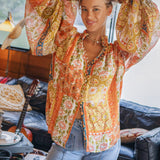 Aurora Blouse Gold Dust showcasing statement sleeves