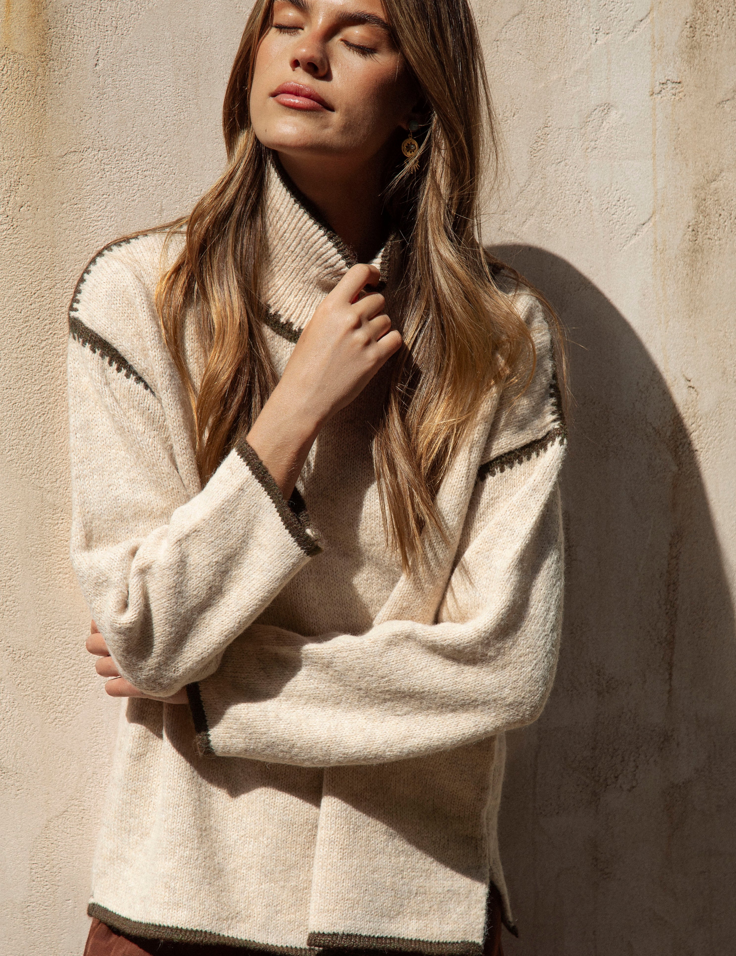 Byron Knit - Olive featuring neutral colourway and contrasting stitch at shoulder, neckline and cuff