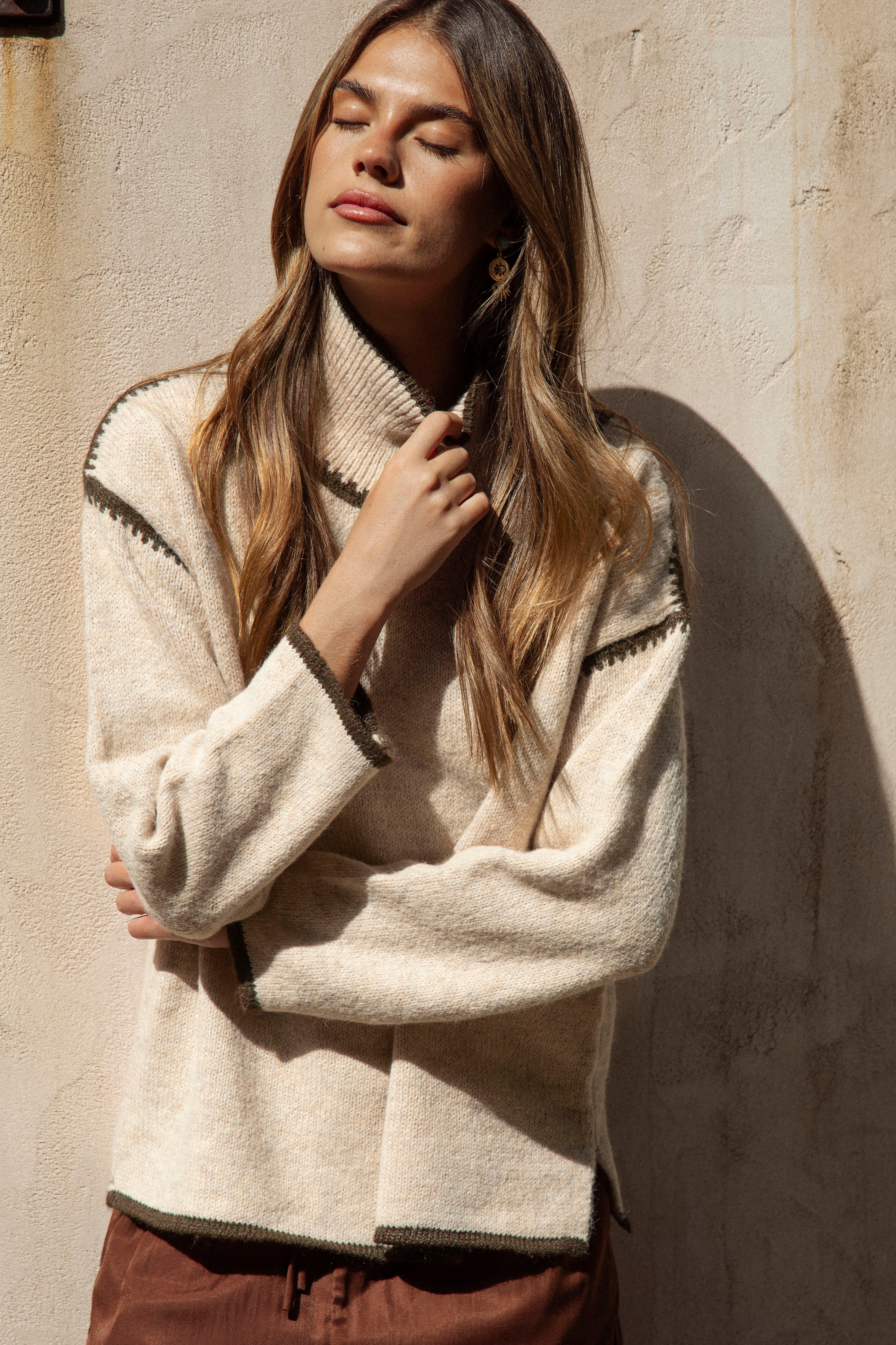 Byron Knit - Olive featuring neutral colourway and contrasting stitch at shoulder, neckline and cuff