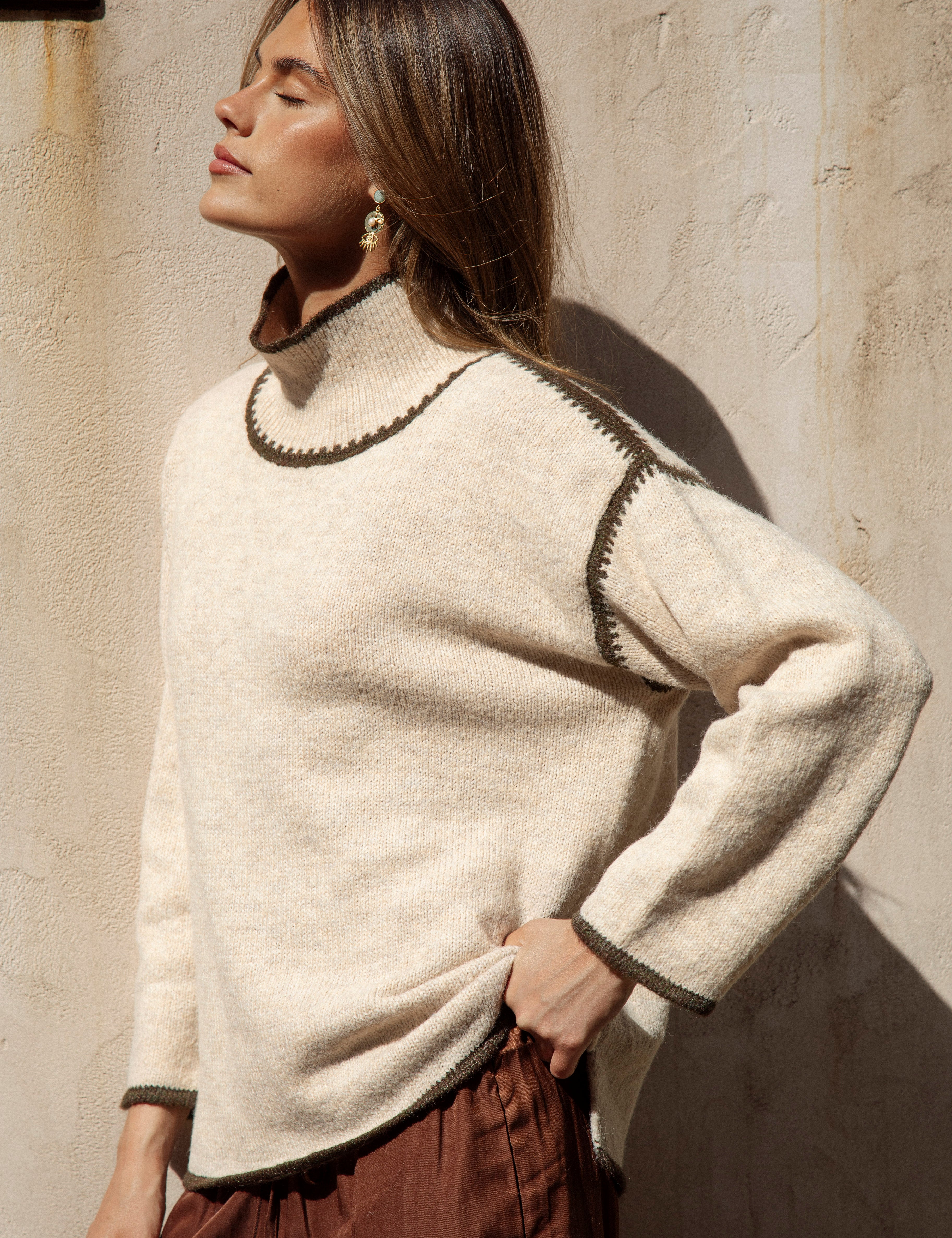  showcasing high neckline and oversized fit