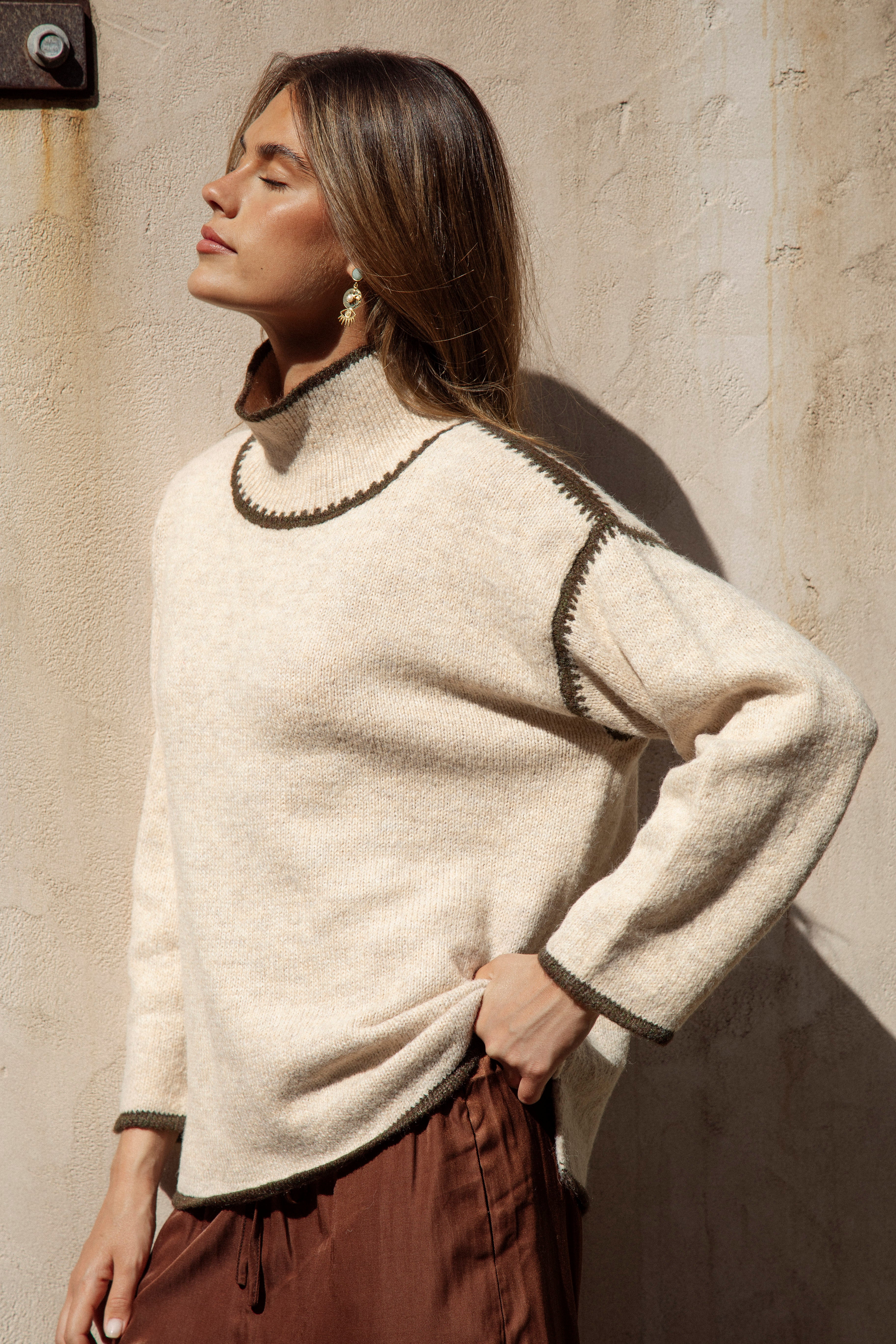  showcasing high neckline and oversized fit