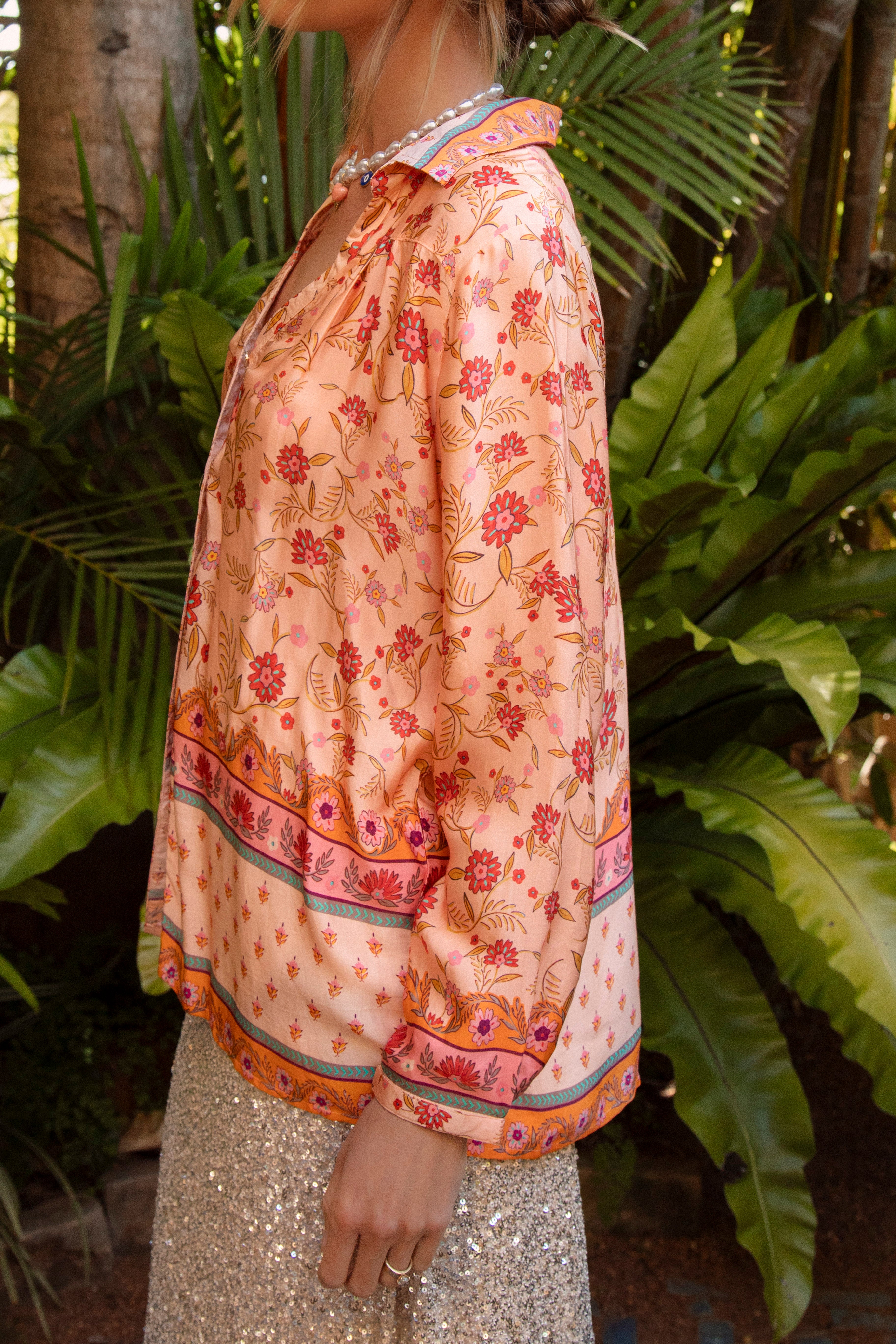 Carnivale Shirt Peach showcasing floral inspired Boho pattern with contrasting trim at hem