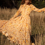 Clementine Maxi Dress featuring a vintage-inspired floral pattern in shades of orange and brown