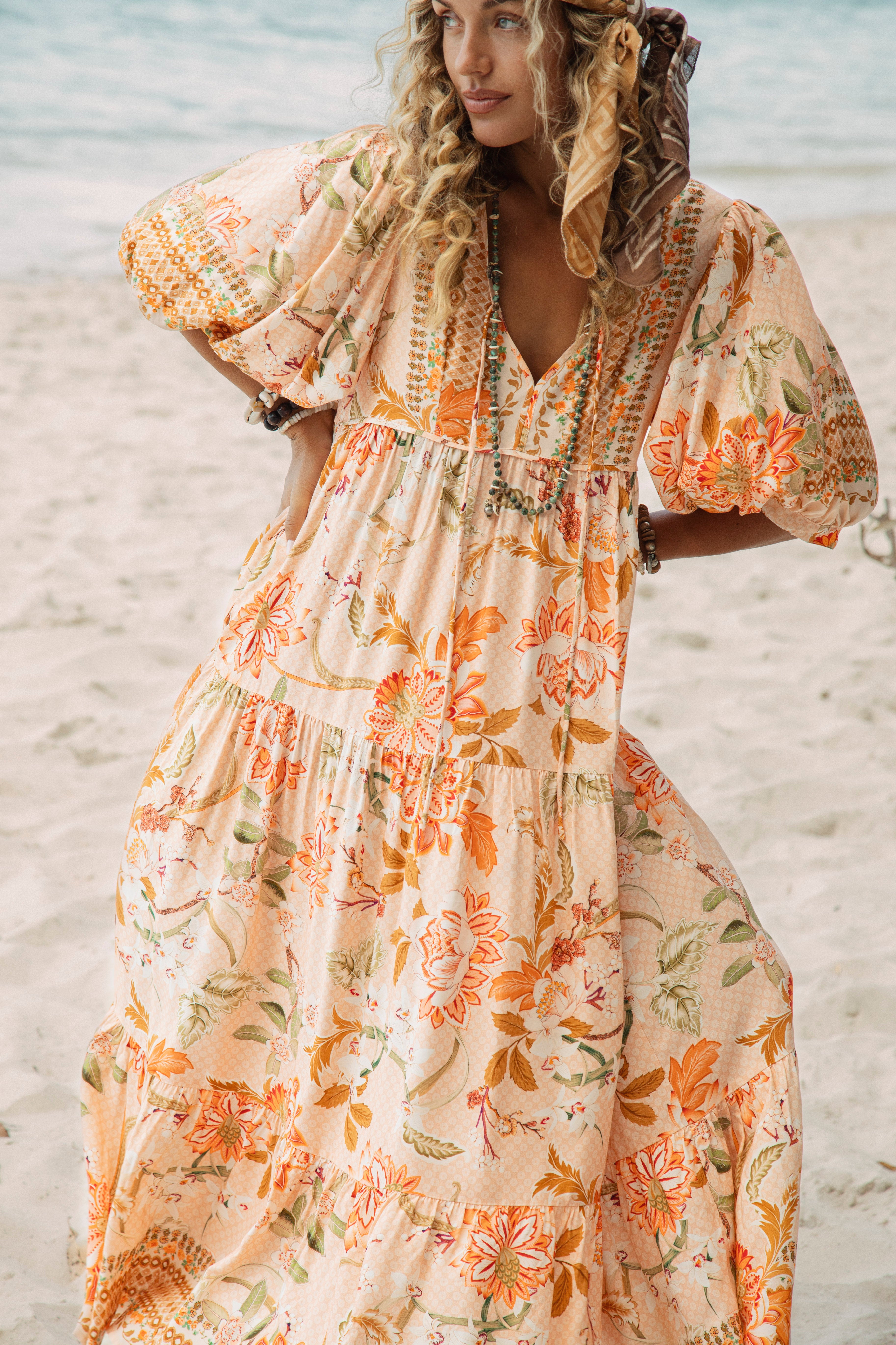 Coral Sands Smock Dress features a Boho inspired floral pattern in shades of peach and orange