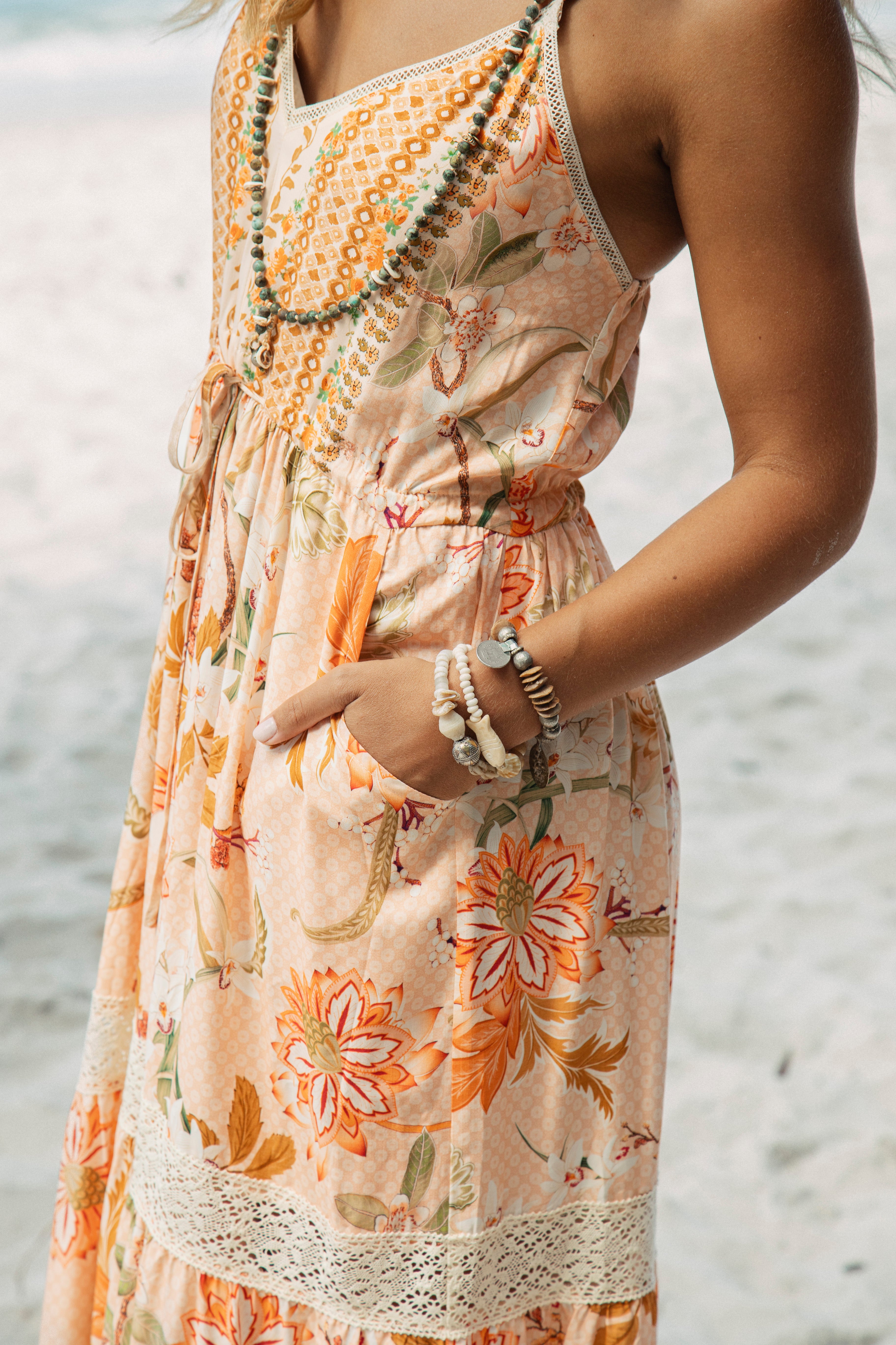 Coral Sands Sundress featuring Boho inspired floral pattern in shades of orange and side pockets
