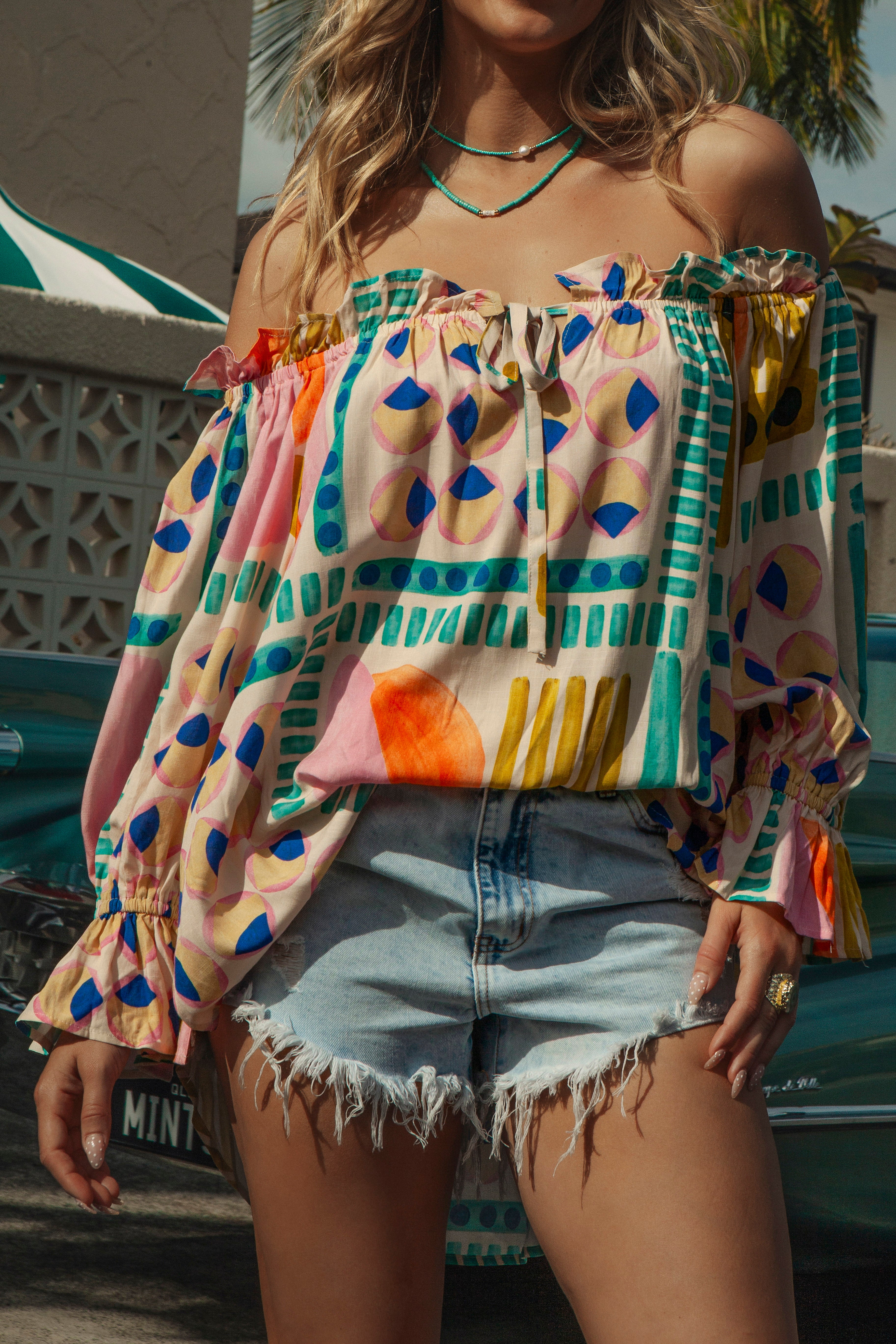 Cosmic Blouse Retro Groove features off the shoulder style and bold retro pattern