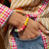 Cosmo Shirt Sandy - close up view of beige and white stripes and contrasting checkered trim in pink and green