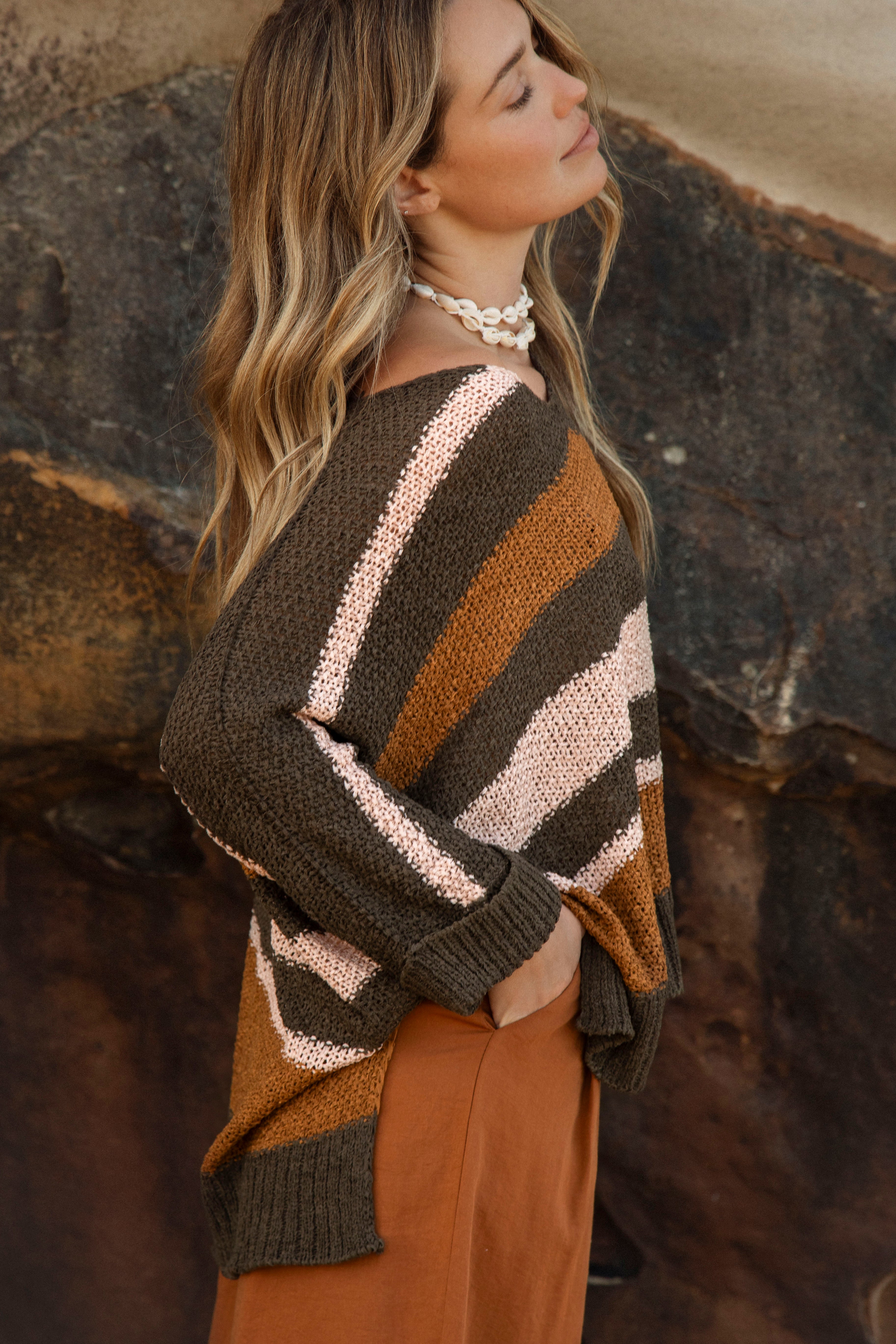 Cove Slouch Knit features wide khaki, rust and cream stripe. Side View.