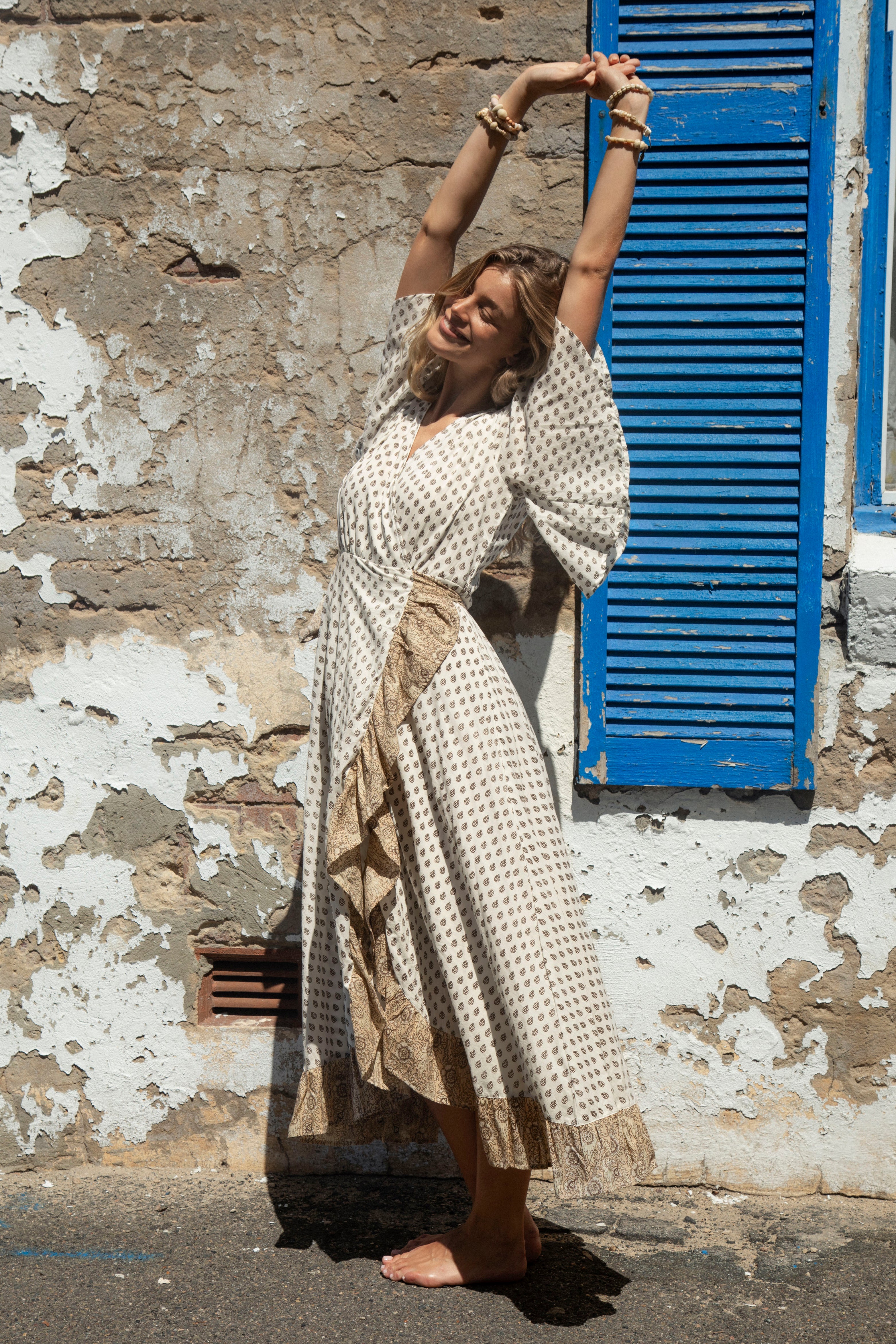 Daisy Wrap Dress Saffron features ruffle detail and flutter sleeves