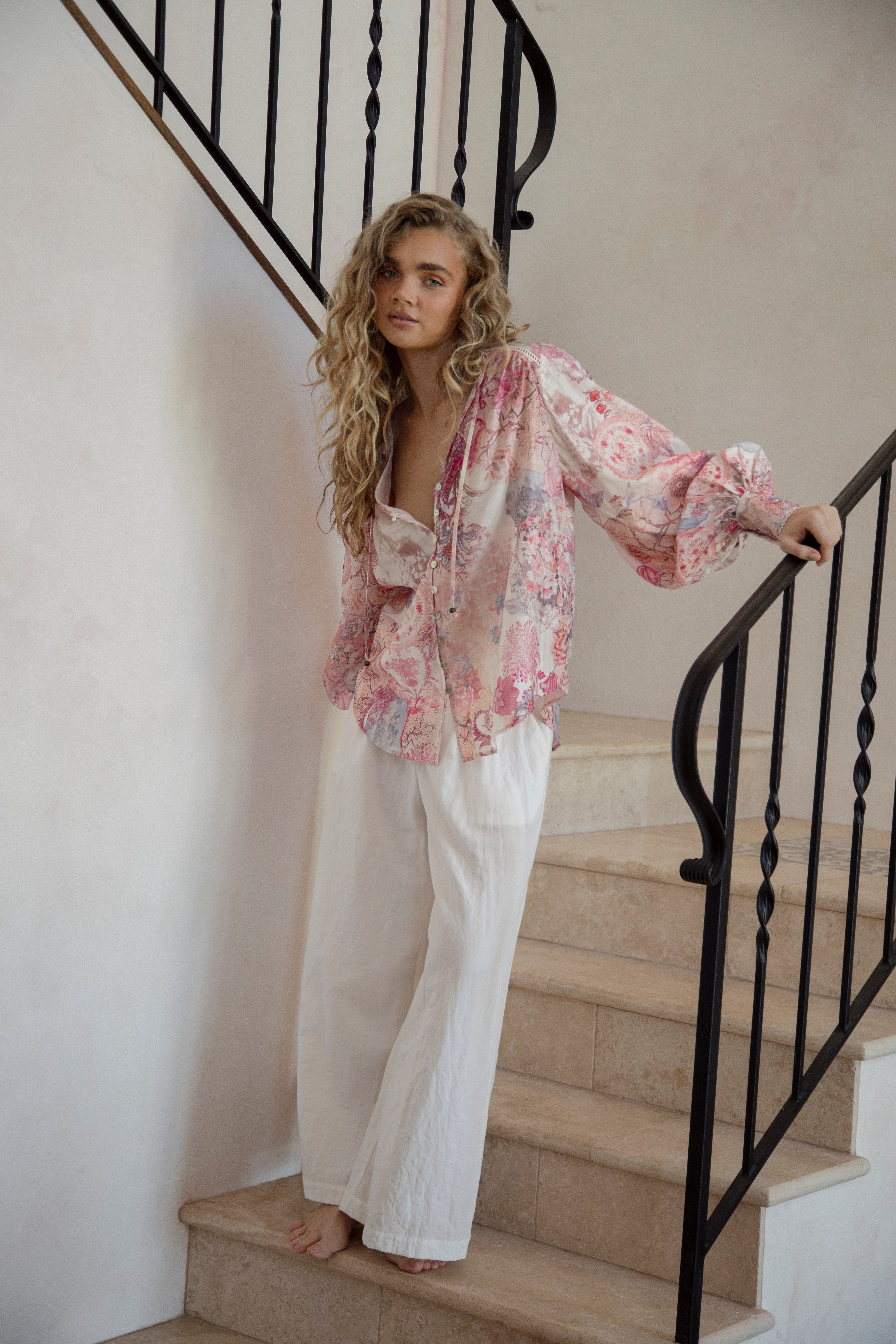 Daphne Blouse Posie featuring long billowy sleeves, button down style and delicate floral pattern in shades of pink