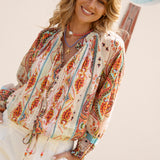 Delfi Blouse Rio features a vibrant paisley pattern in shades of tangerine and aqua on cream colourway