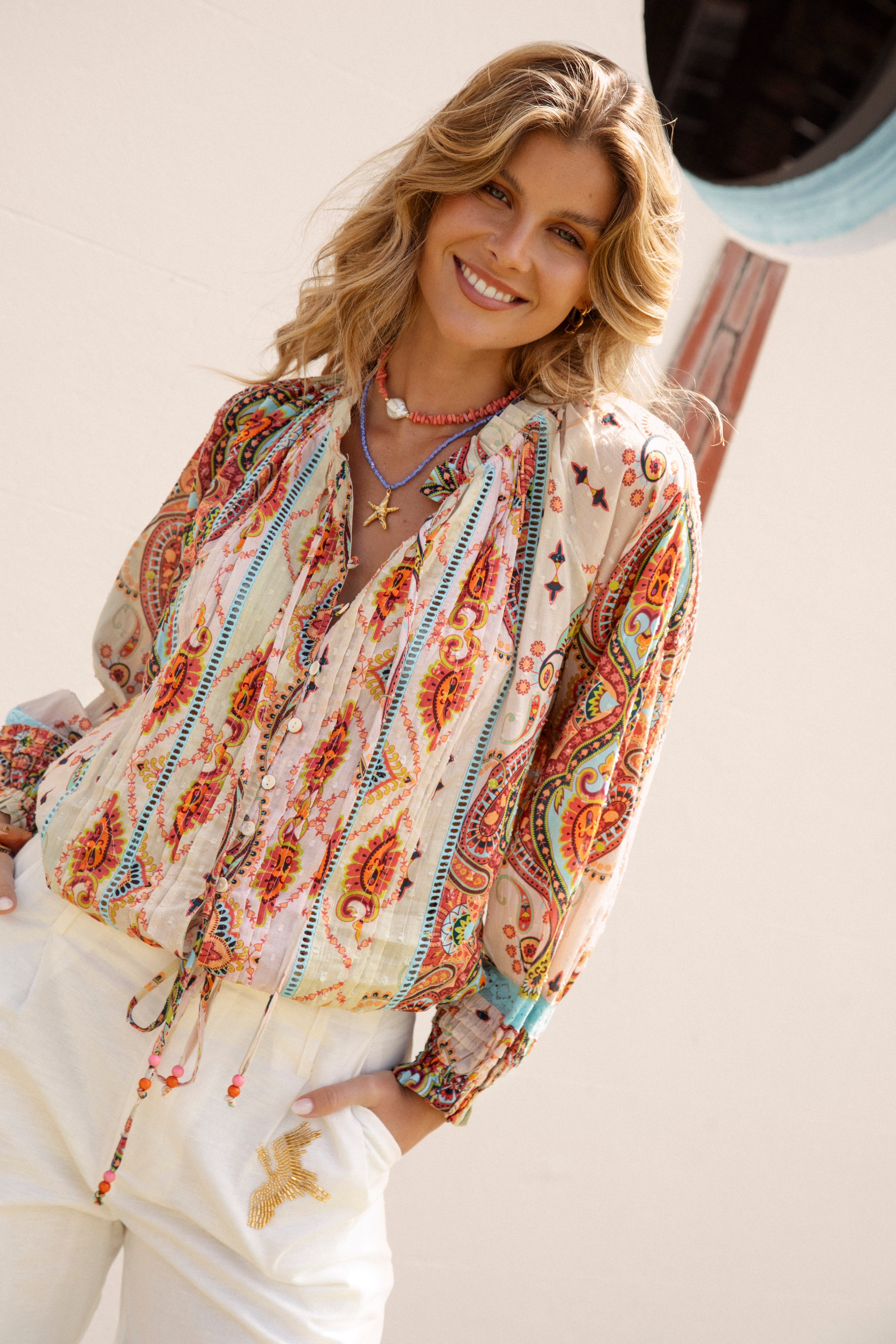 Delfi Blouse Rio features a vibrant paisley pattern in shades of tangerine and aqua on cream colourway