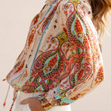 Delfi Blouse Rio - side view showcasing vibrant paisley print, billowy sleeves and shirred cuff detail.