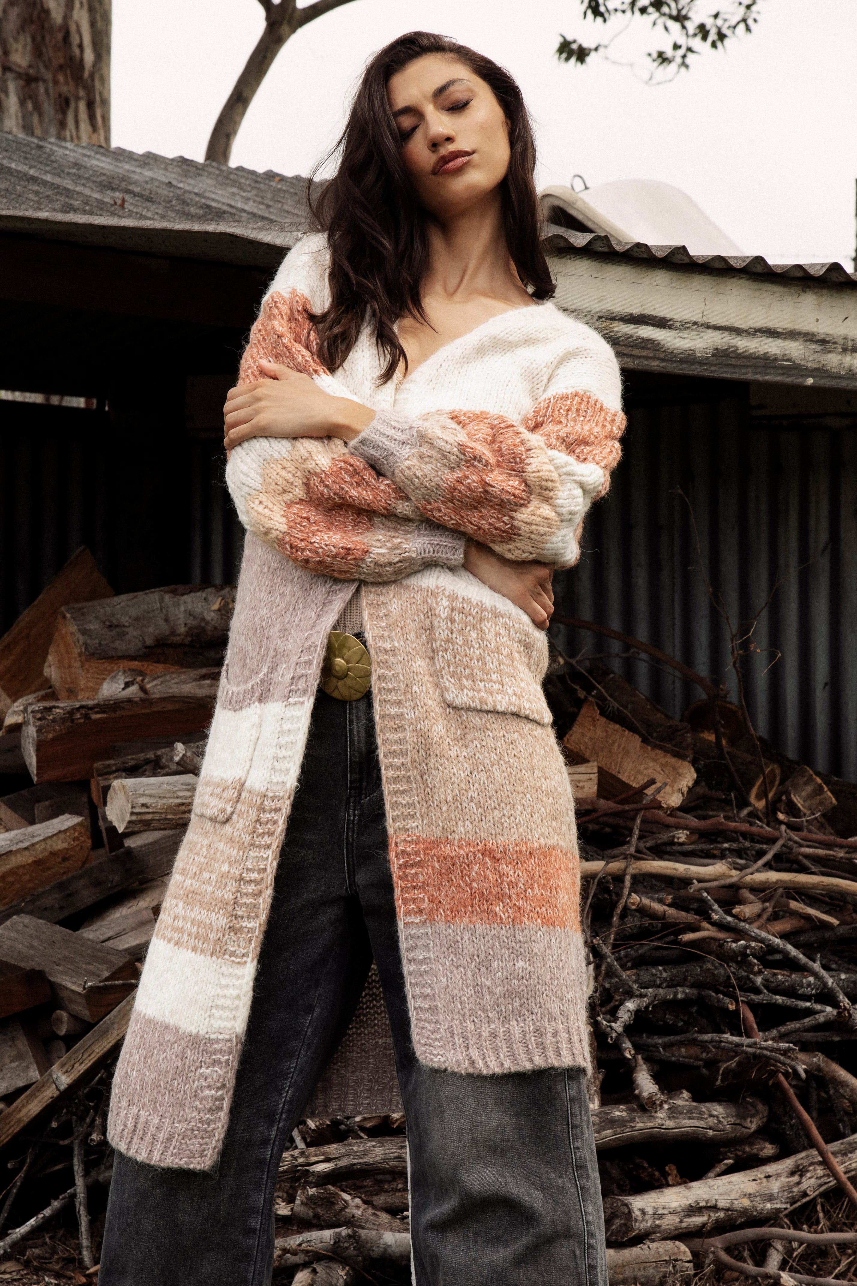 Dusk Horizon Cardigan is a long line cardigan featuring a striped pattern in earthy tones of beige, brown and orange.