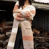 Dusk Horizon Cardigan is a long line cardigan featuring a striped pattern in earthy tones of beige, brown and orange.