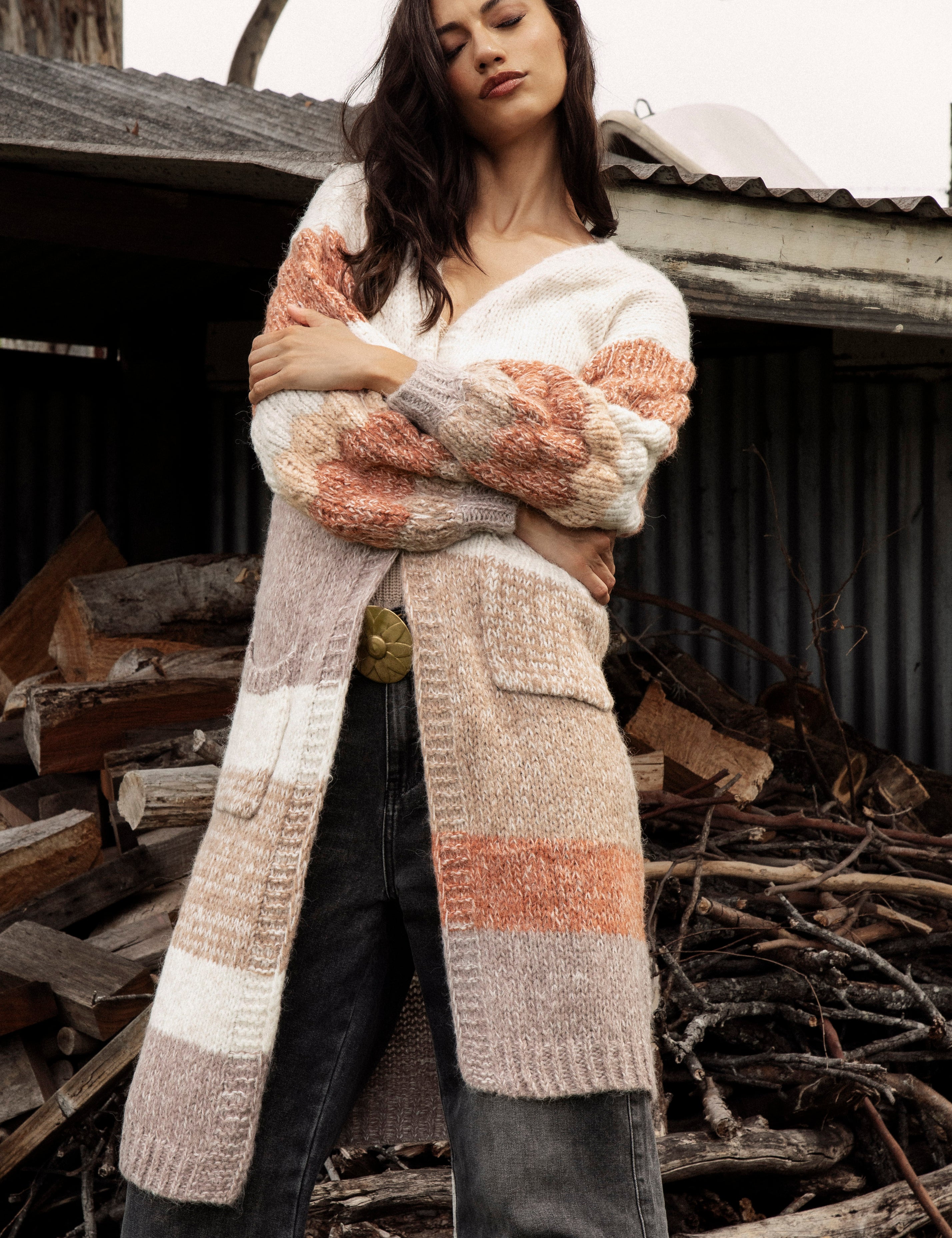 Dusk Horizon Cardigan is a long line cardigan featuring a striped pattern in earthy tones of beige, brown and orange.