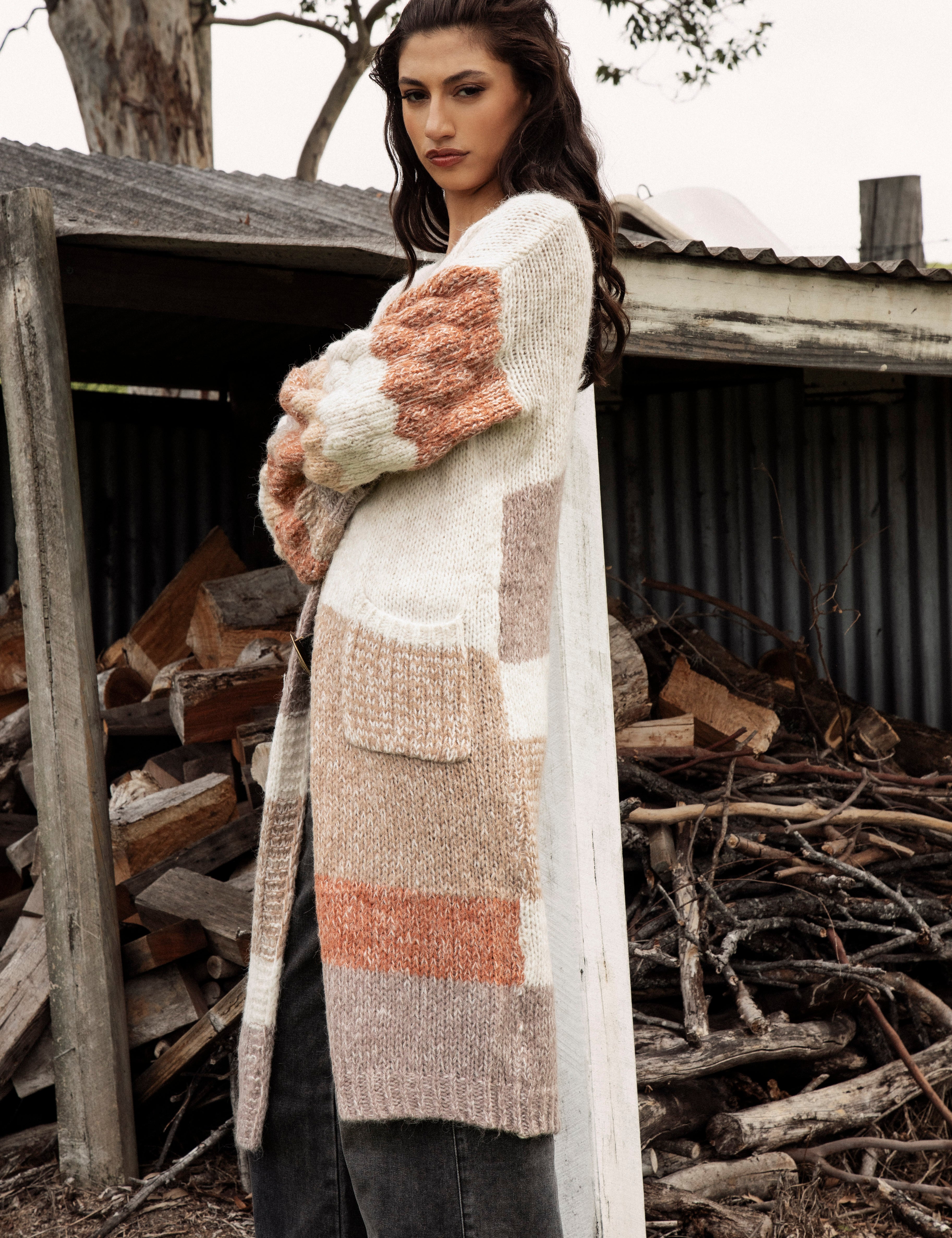 Dusk Horizon Cardigan. Side view showcasing billowy sleeves in chunky knit.