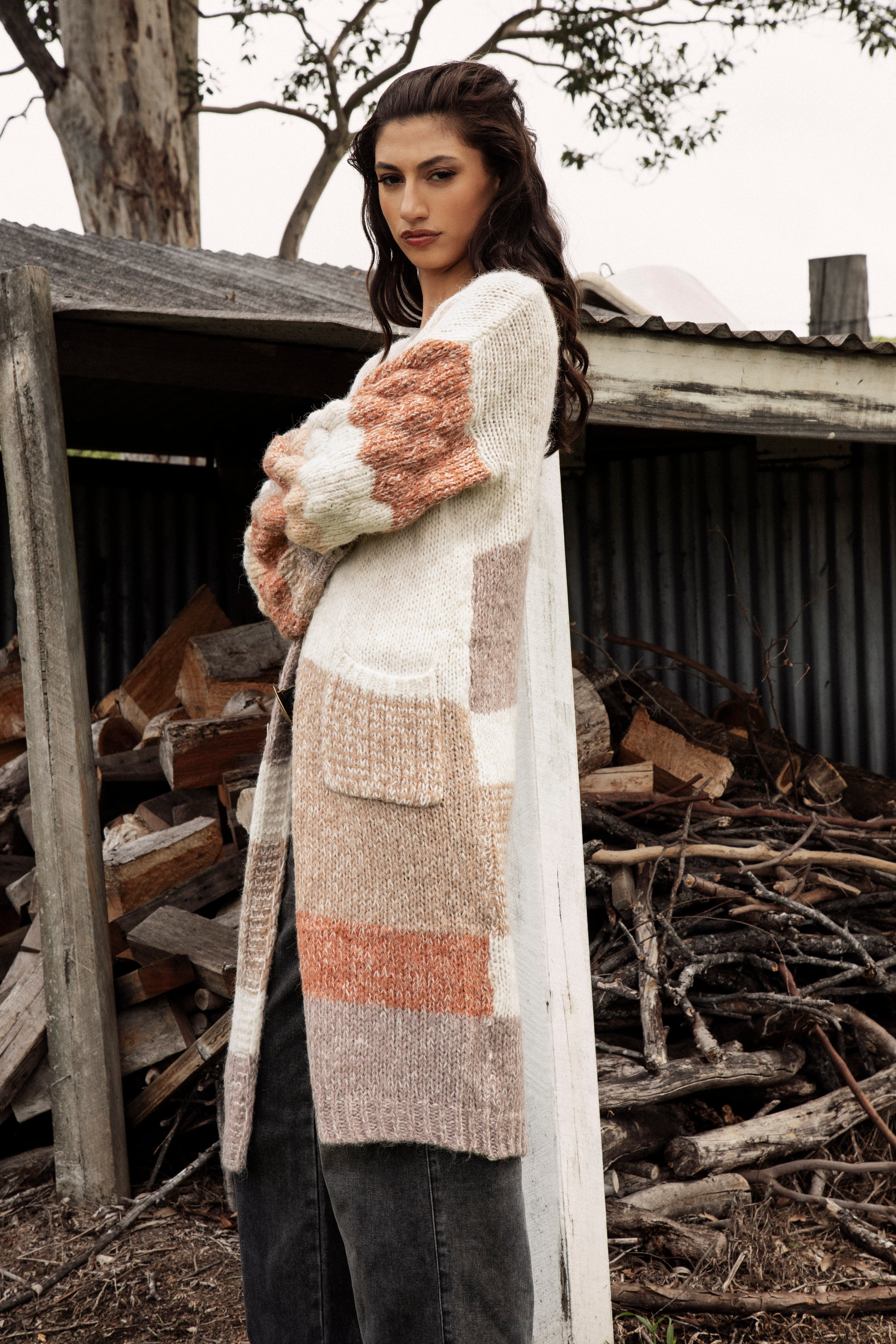 Dusk Horizon Cardigan. Side view showcasing billowy sleeves in chunky knit.