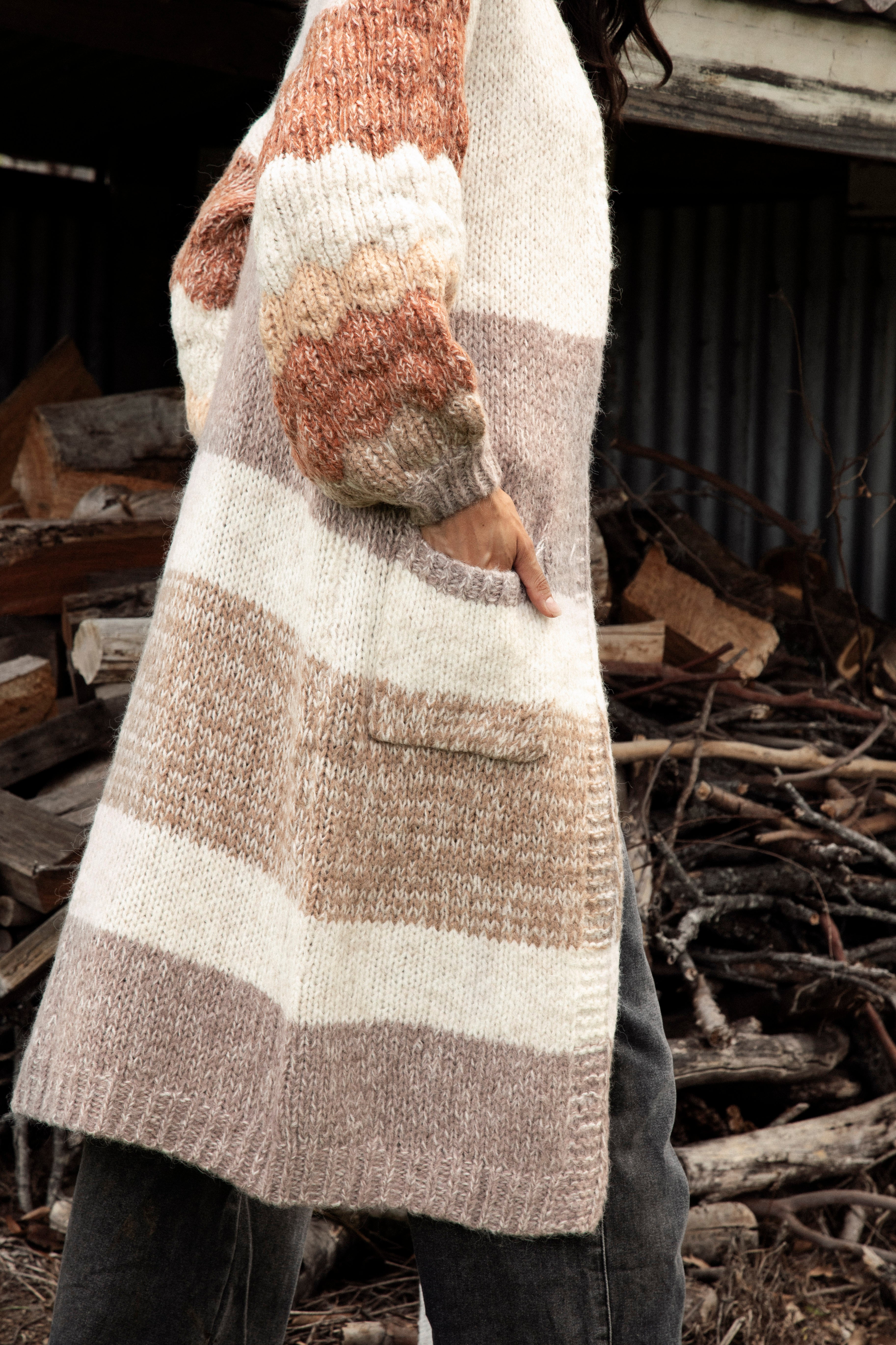 Dusk Horizon Cardigan showcasing pockets, longline length and chunky knit sleeves.