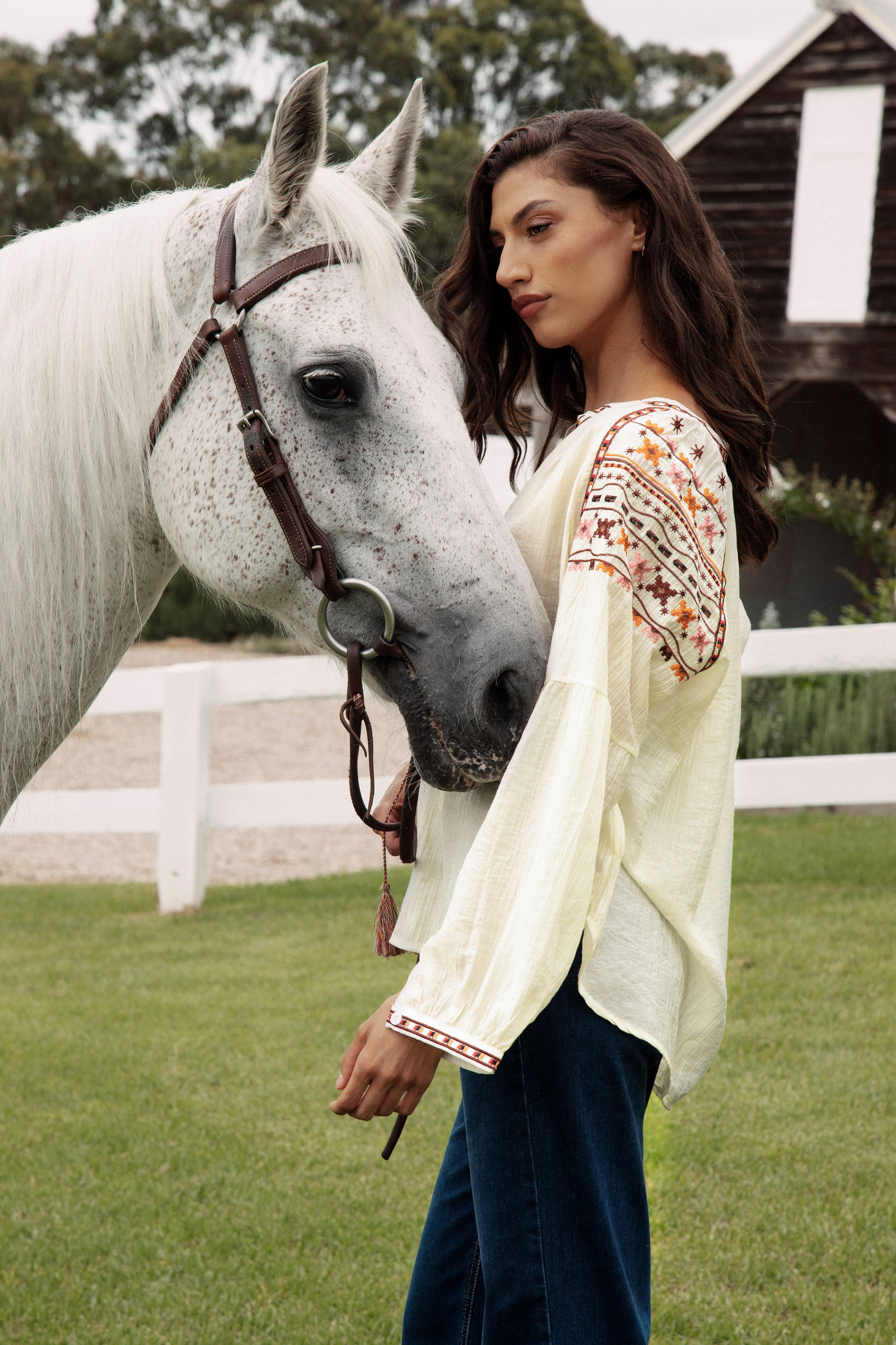 Eve Embroidered Blouse Side View showcasing floral embroidery in Autumnal tones on sleeve.