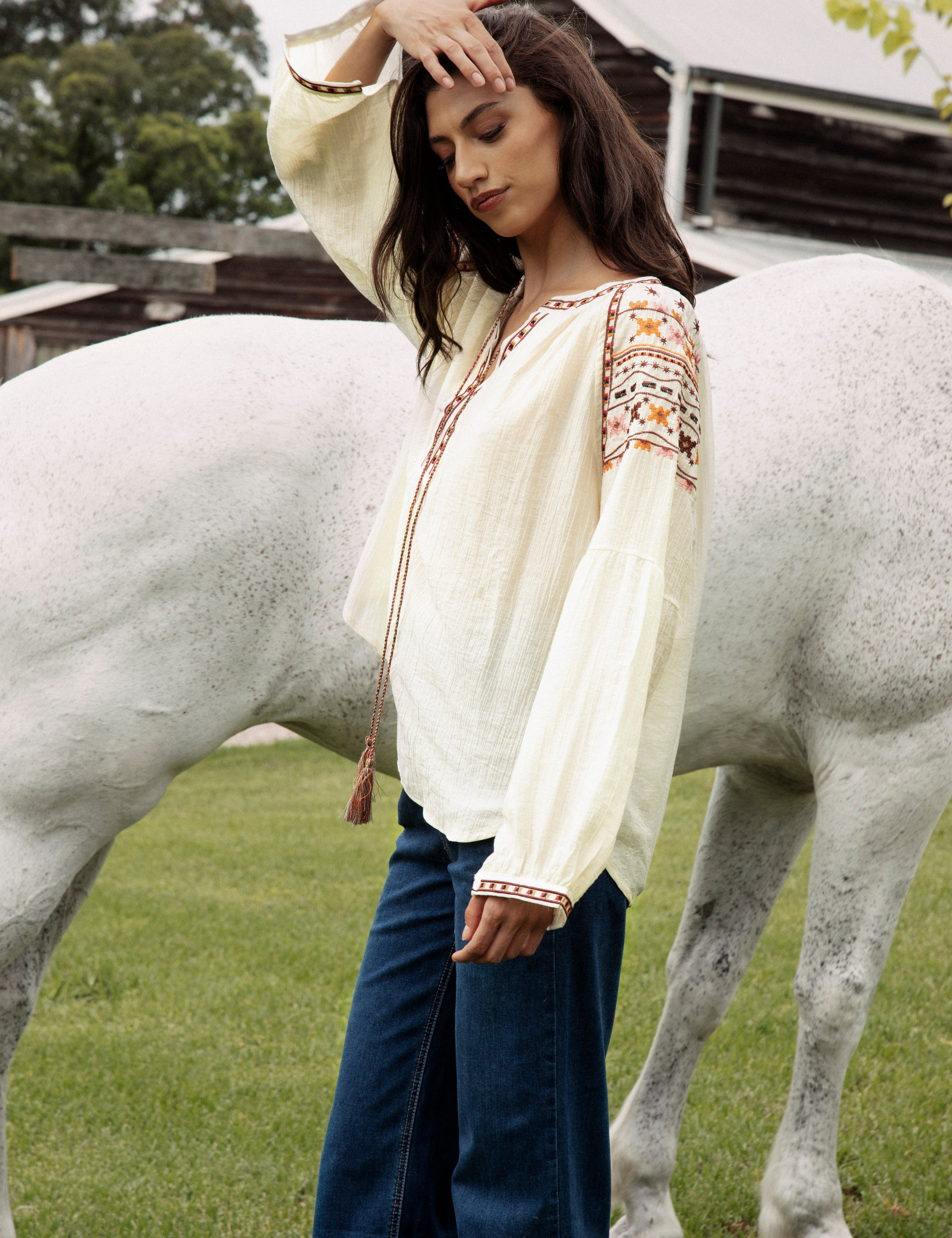 Eve Embroidered Blouse is a cream coloured long sleeve Boho style blouse with delicate embroidery at sleeves in shades of yellow, brown and pink.