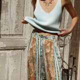Georgie Pant Olive showcasing tailored fit with button and zip closure, pleated style and pockets.