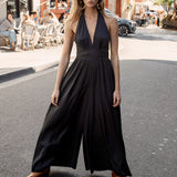 Gigi Jumpsuit Black - featuring plunging v-neckline and halter neck style finished with wide leg pant