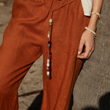 Gigi Pant Terracotta showcasing beaded detail on tie waist