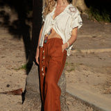 Gigi Pant Terracotta showcasing relaxed fit and pockets