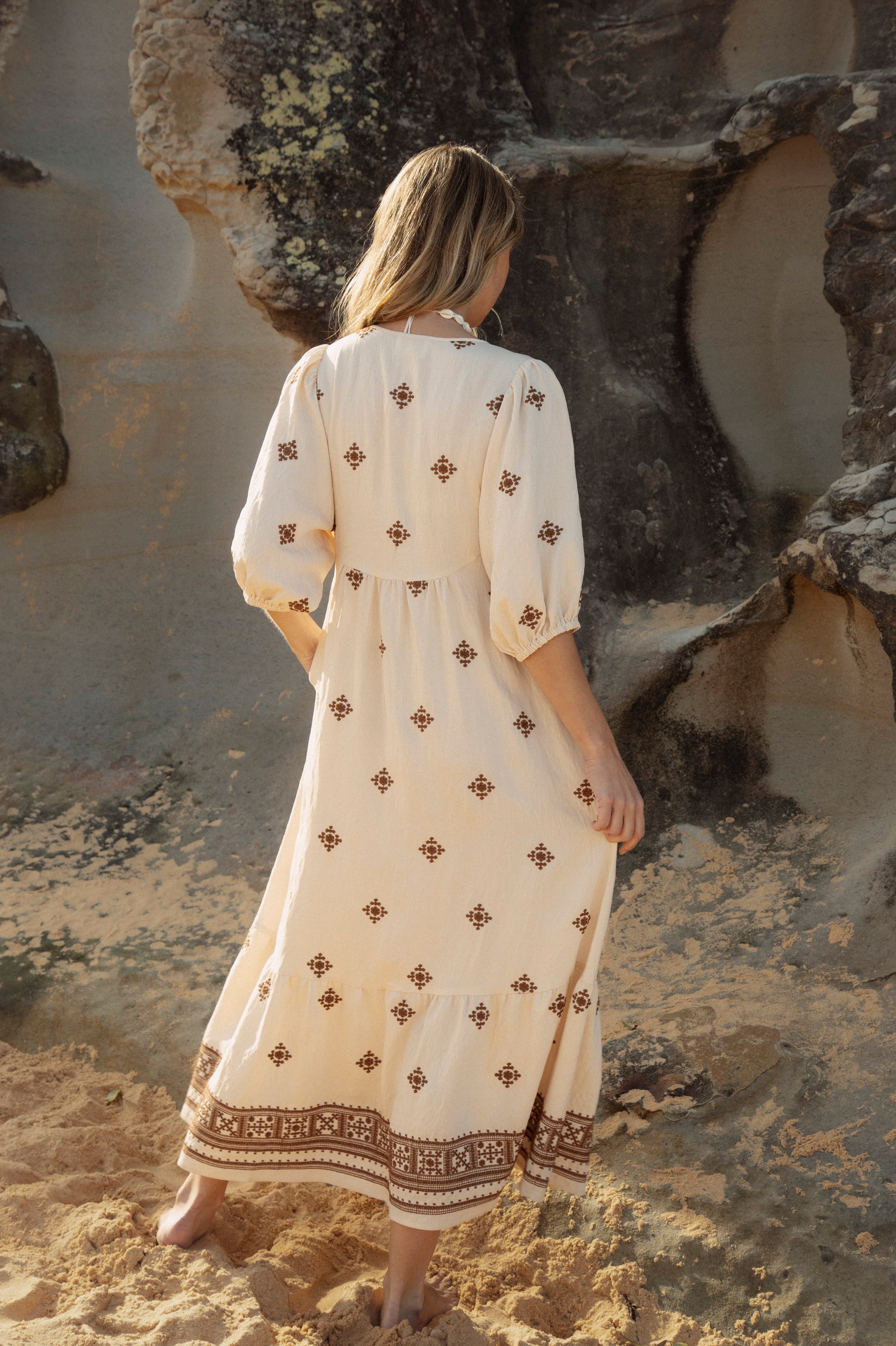 Indira Sundress - cream coloured maxi dress featuring moroccan inspired embroidered pattern in brown. Rear View.