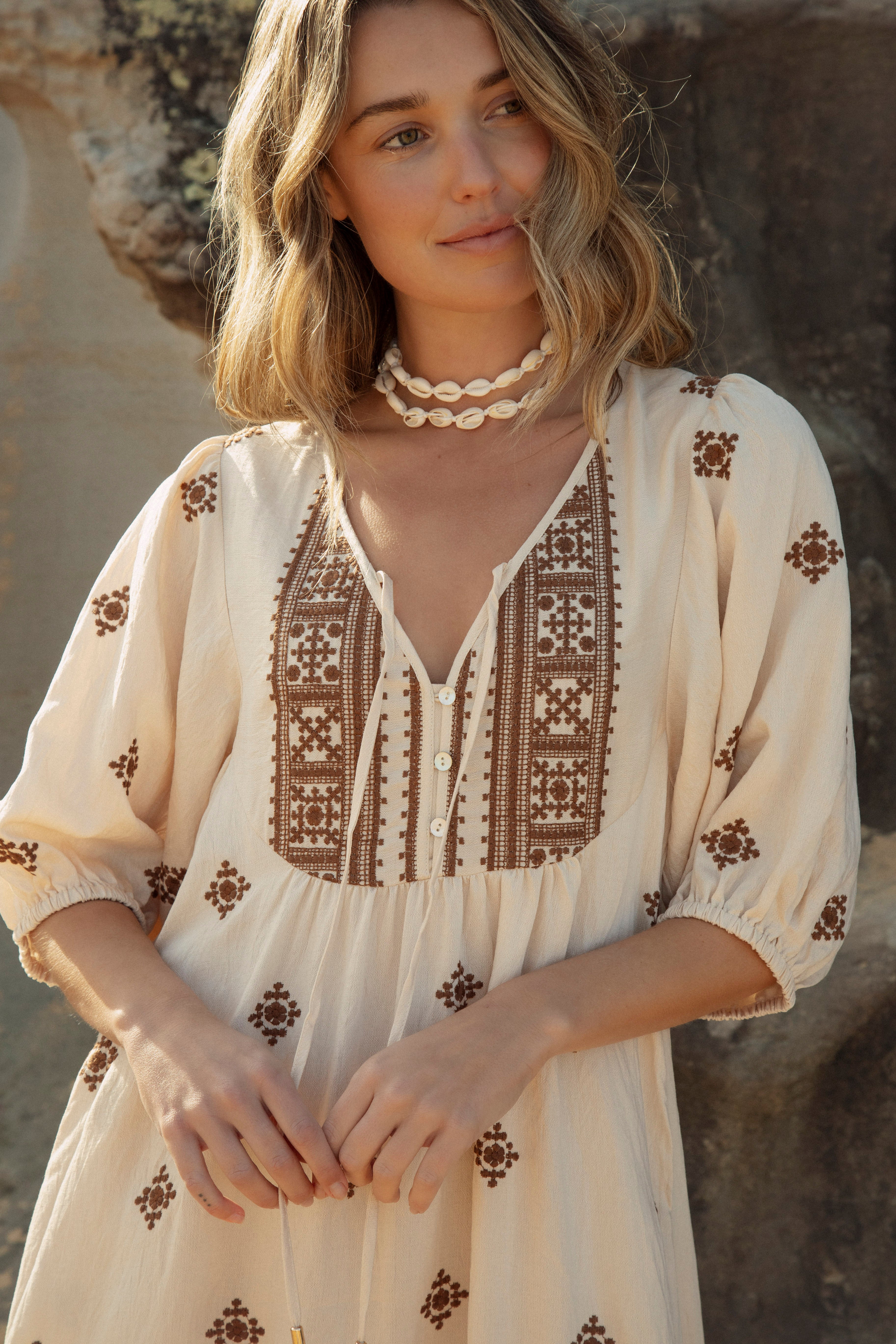 Indira Sundress is a Boho style maxi dress in earthy tones. Features Moroccan inspired embroidered pattern throughout.