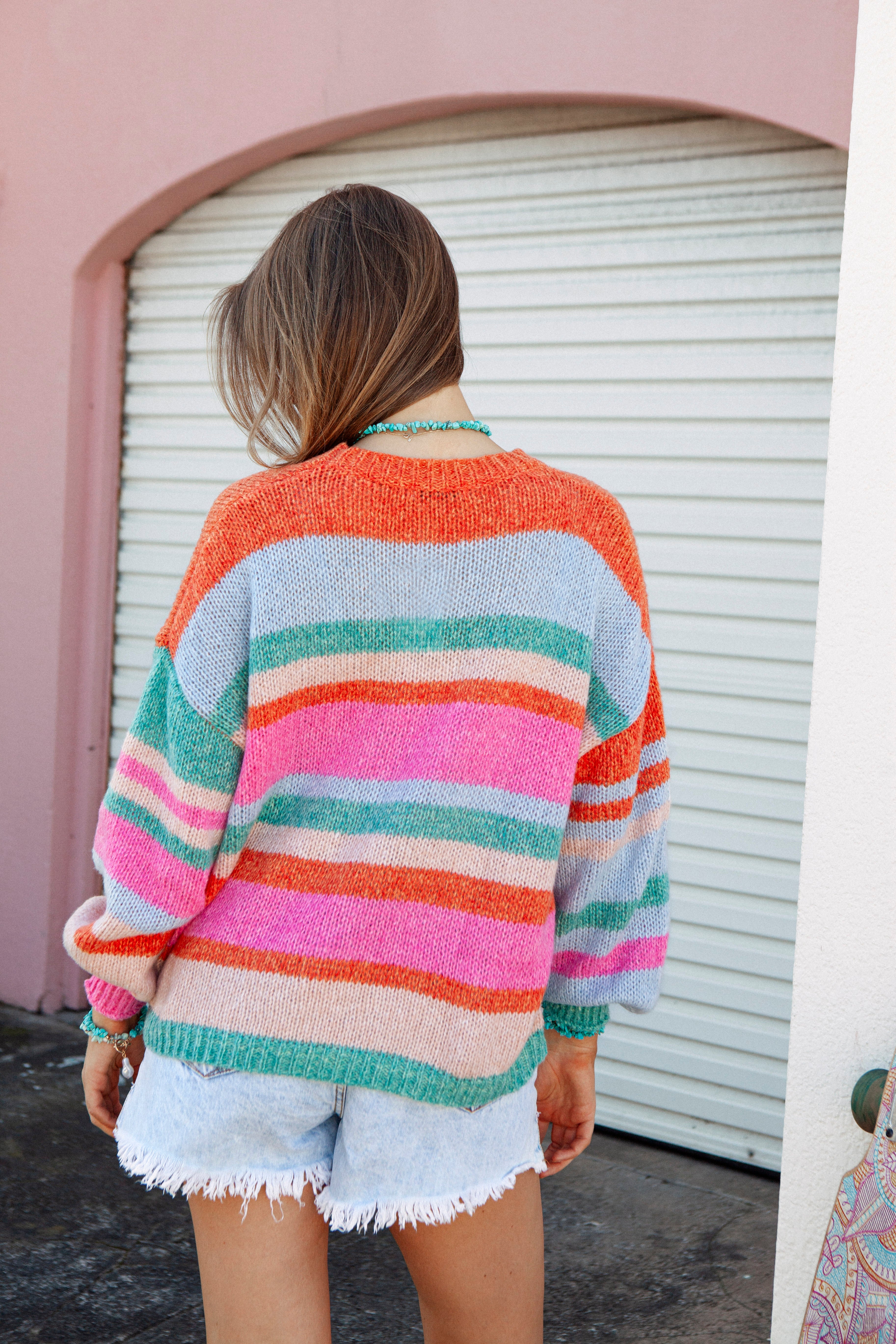 Iris Striped Knit. Rear view showcasing bright striped pattern.