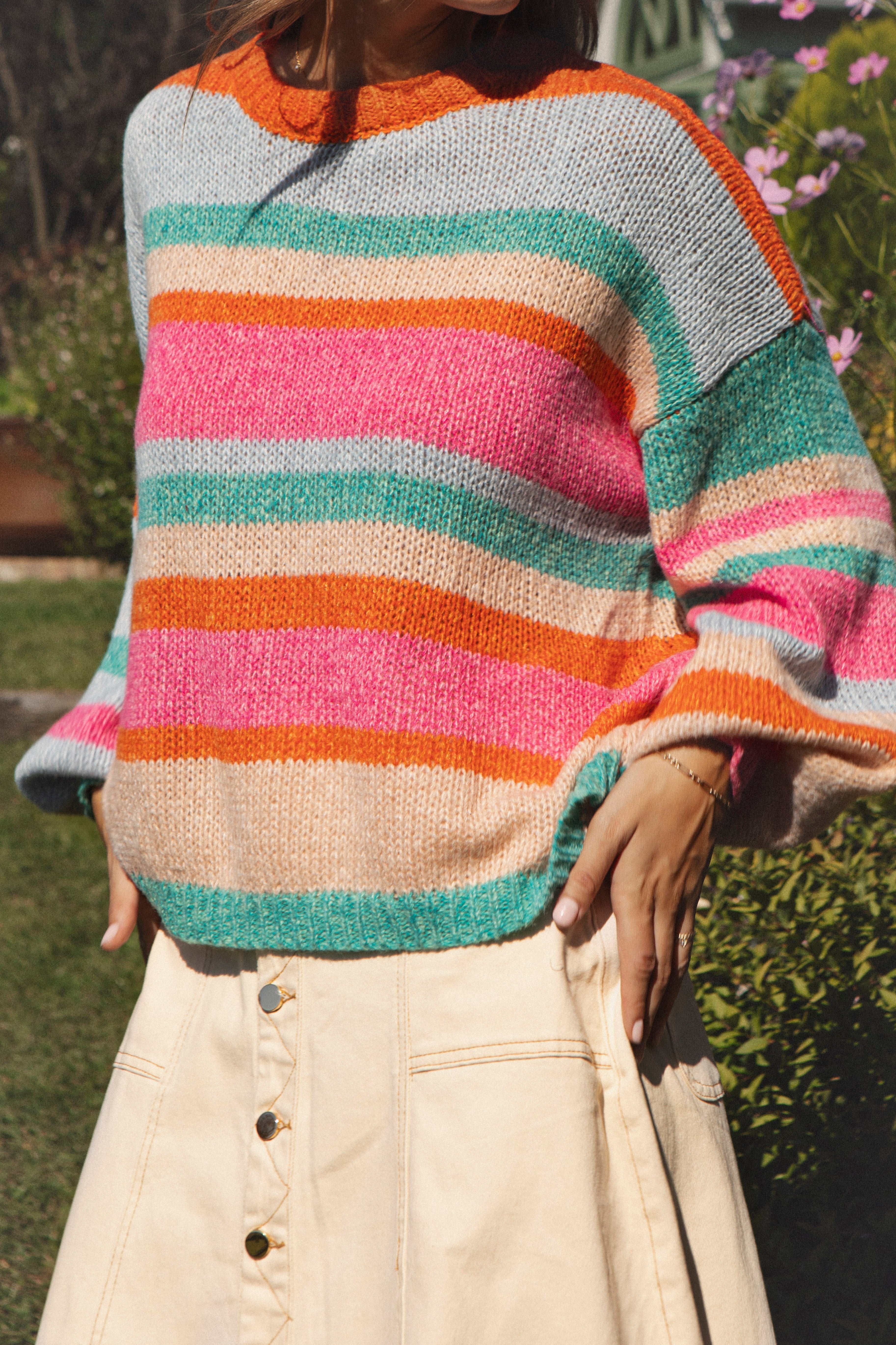 Iris Striped Knit. Long sleeved striped sweater in orange, pink, aqua, beige and blue.