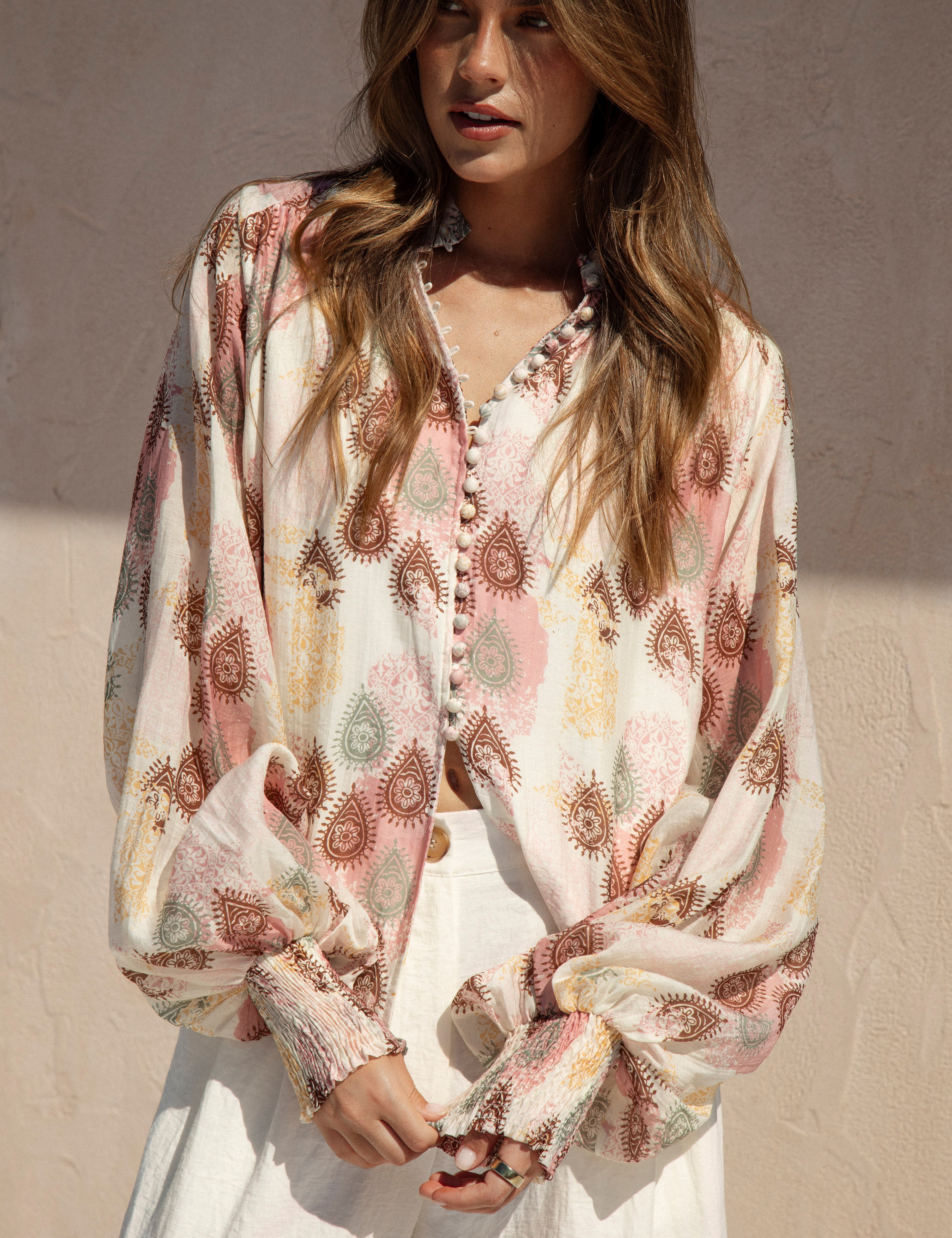 Isla Blouse Mauve Paisley features long billowy sleeves, shirred cuffs and button down style