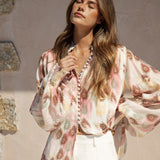 Isla Blouse Mauve Paisley showcasing billowy sleeves and shirred cuffs