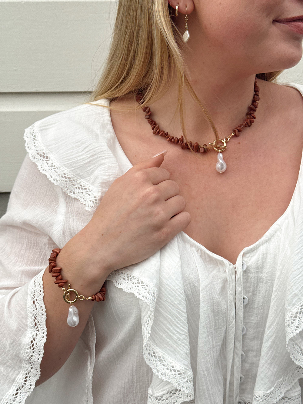 Isla Jewellery Set includes a choker necklace and bracelet featuring rust coloured stone beads and pearl embellishment