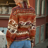 Kasbah Belted Cardigan - rear view showcasing geometric pattern in shades or rust, orange, burgundy, brown and cream