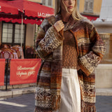 La Vie Cardigan is a chunky knit open-front cardigan with a multicolor pattern of brown, beige, orange, and black worn with Sol Pant - Pearl.