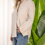 Liza Linen Shirt Oat worn with full length sleeve. Side view.