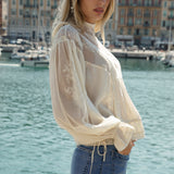 Lumiere Blouse - side view showcasing ruffle at cuffs and lace sleeves