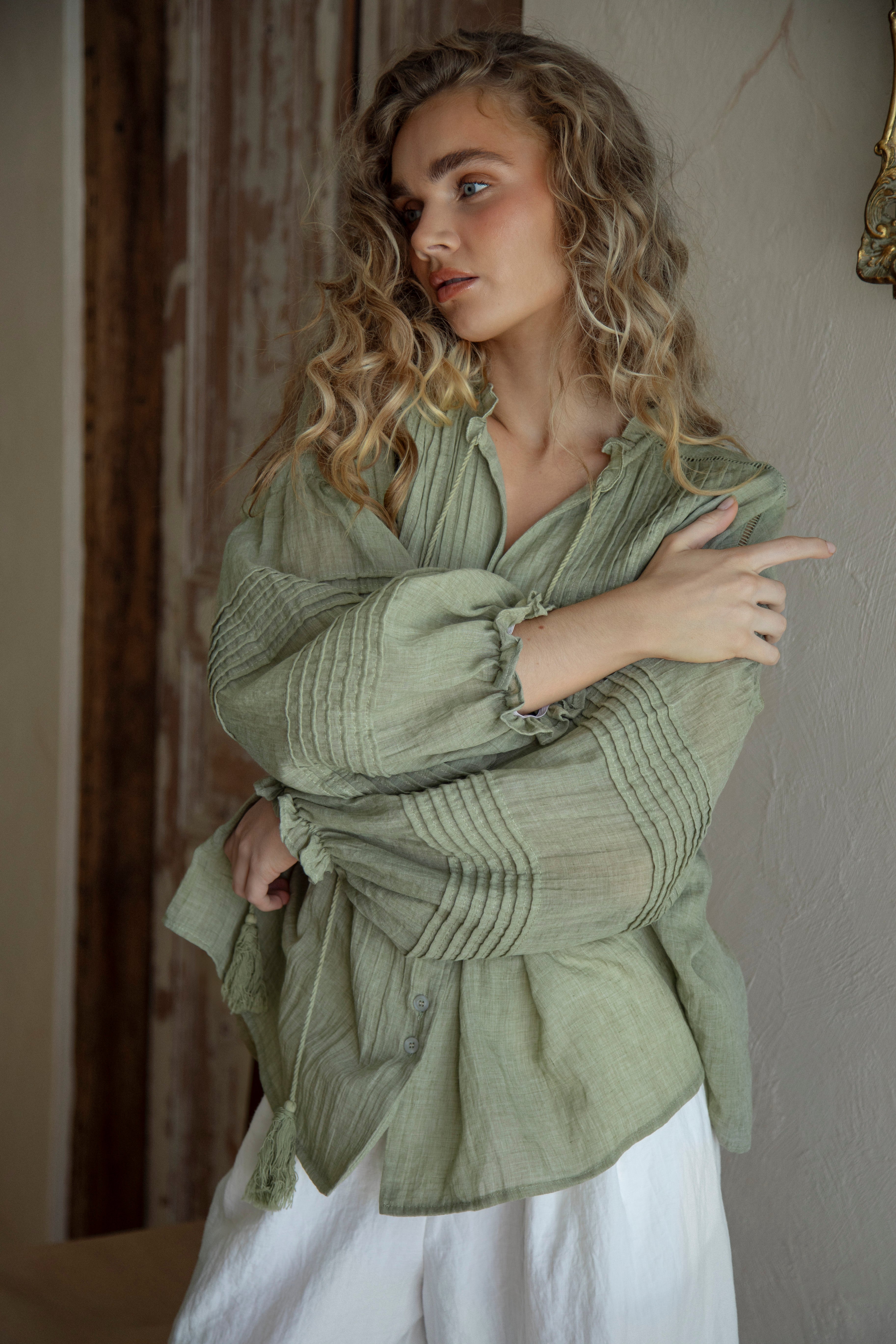 Poppy Blouse Fern - Boho blouse in sage green colourway featuring long sleeves with pintuck detail and tassel decoration at collar.