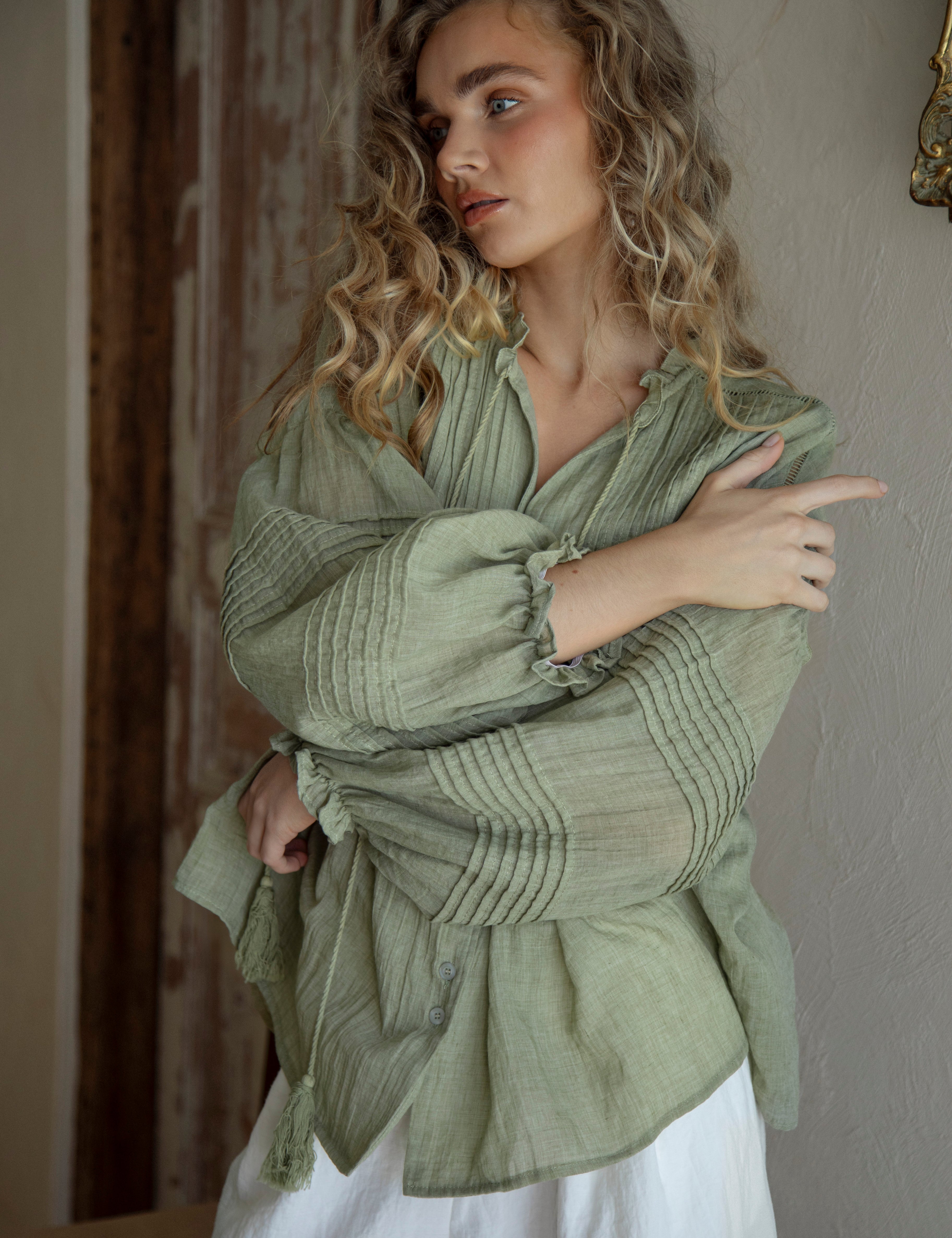 Poppy Blouse Fern - Boho blouse in sage green colourway featuring long sleeves with pintuck detail and tassel decoration at collar.