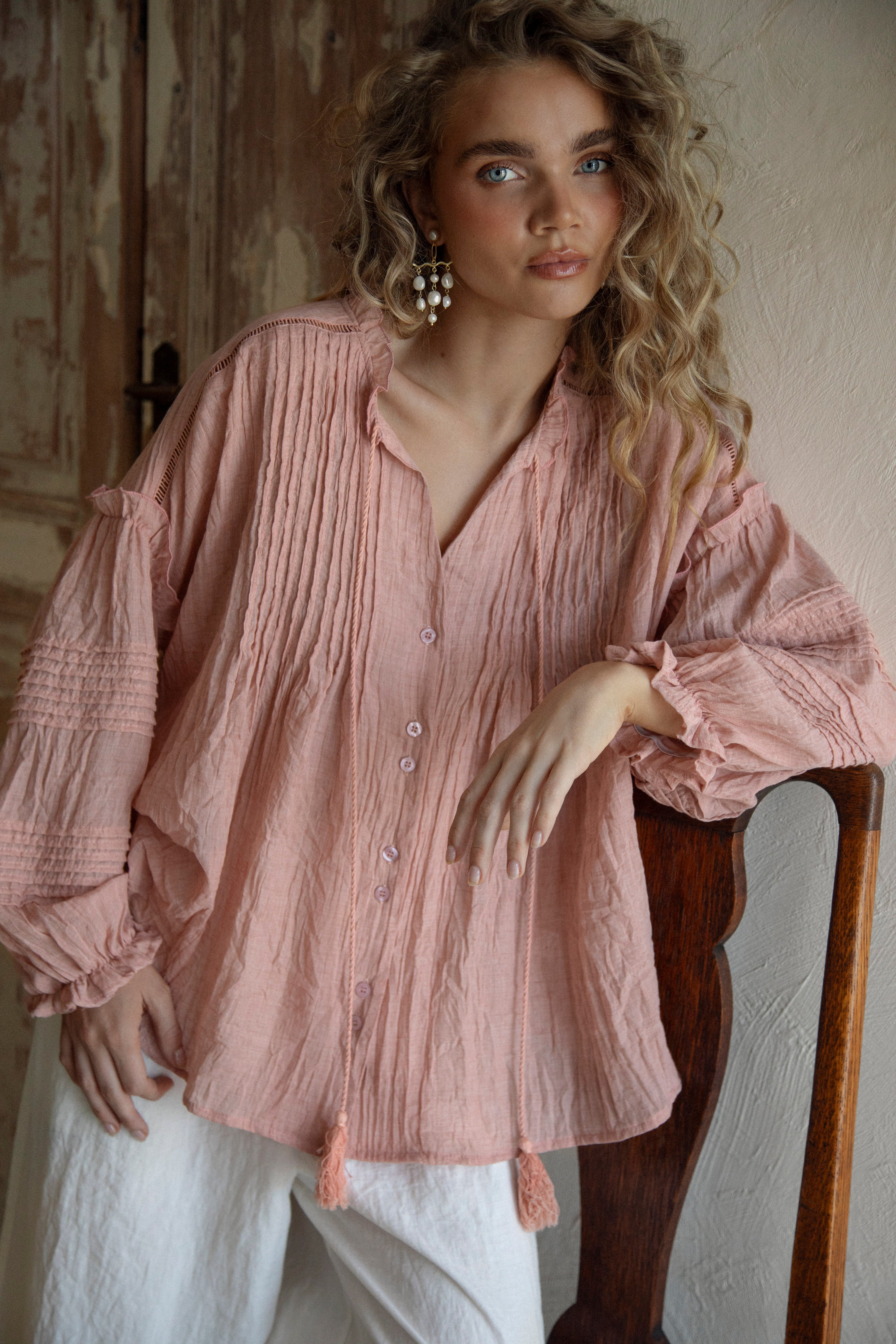 Poppy Blouse Rose features long sleeves, boho style, pleated details and button down front.