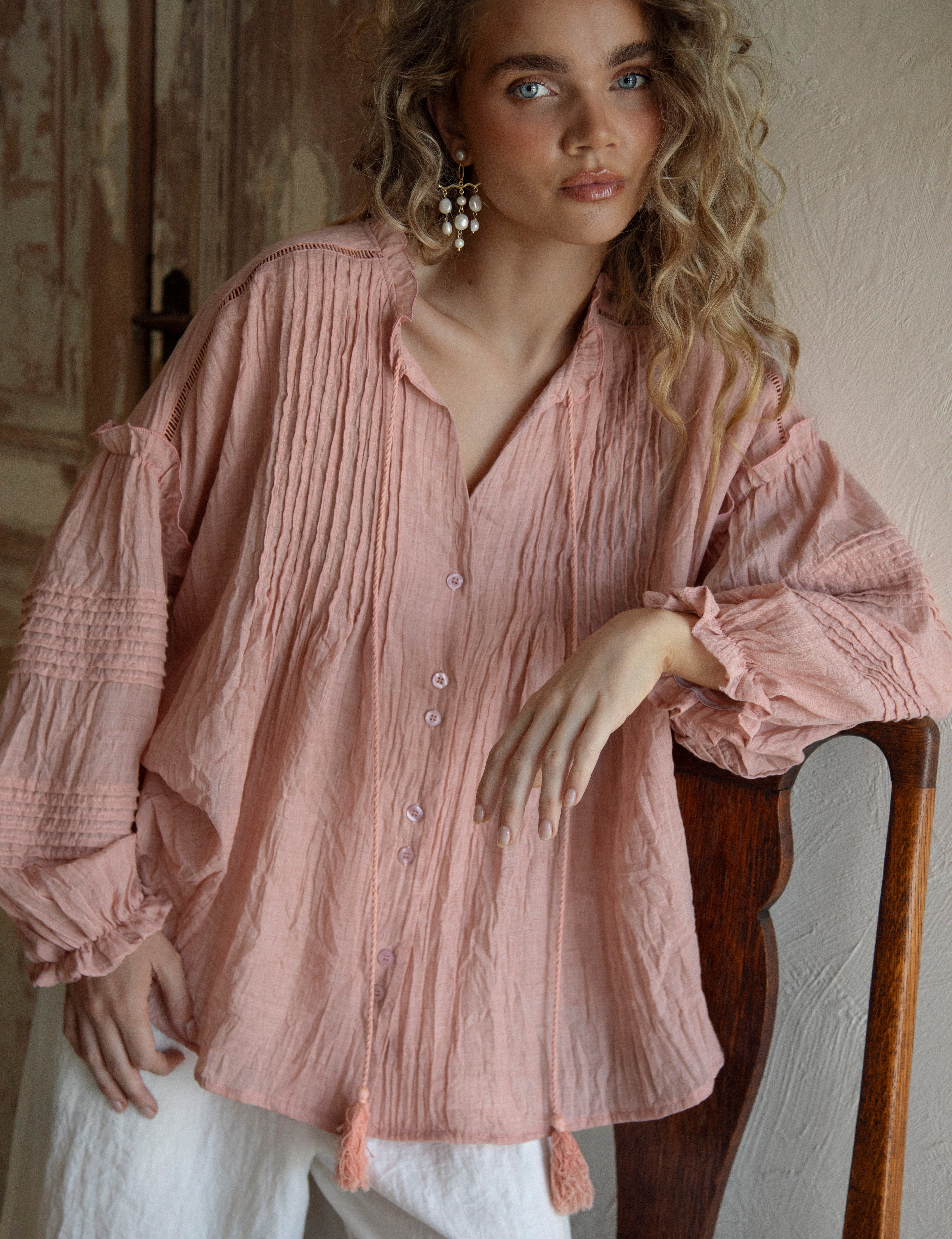 Poppy Blouse Rose features long sleeves, boho style, pleated details and button down front.