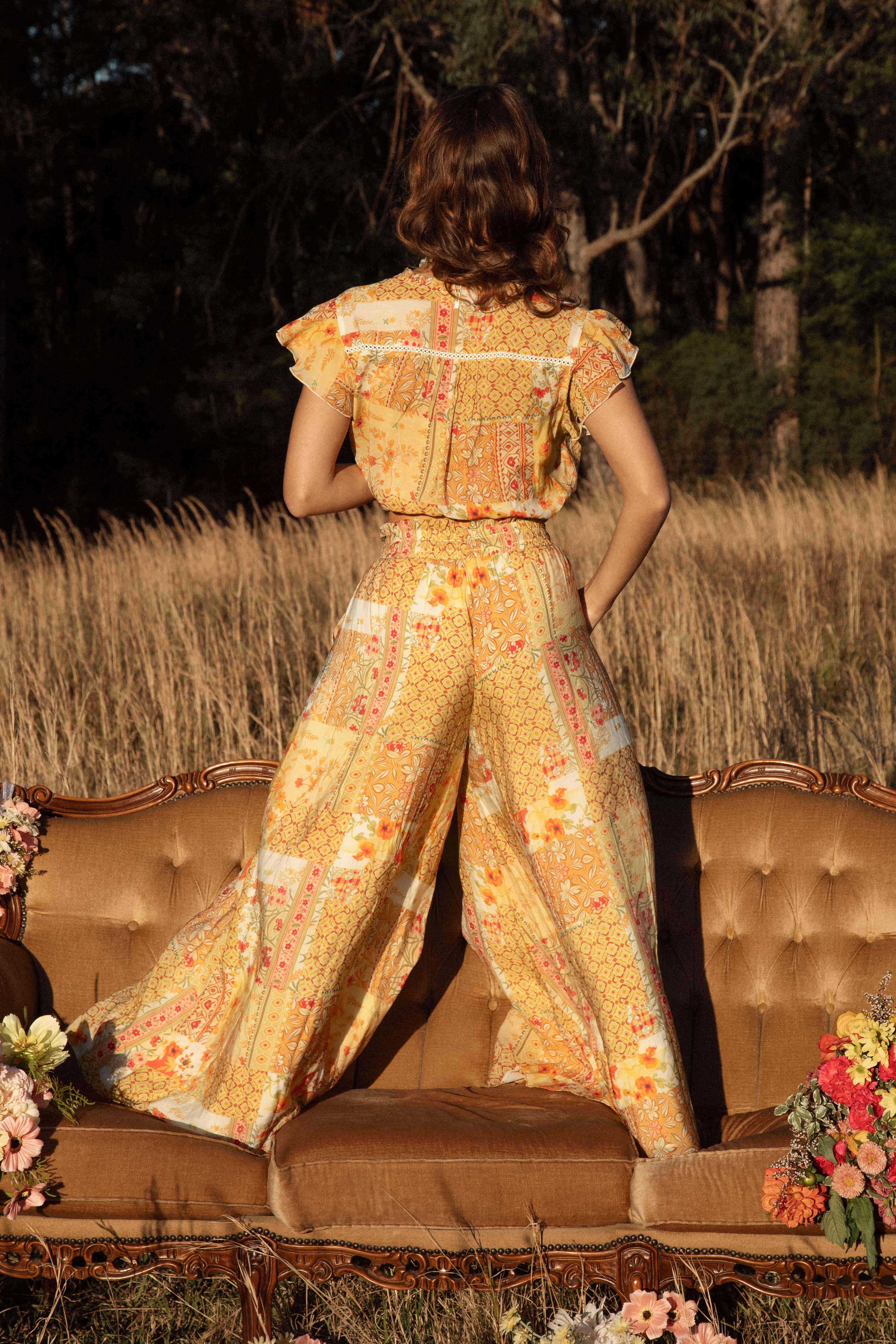 Resort Pant Fields of Gold - rear view showcasing vintage-inspired floral pattern in shades of yellow, brown and orange.